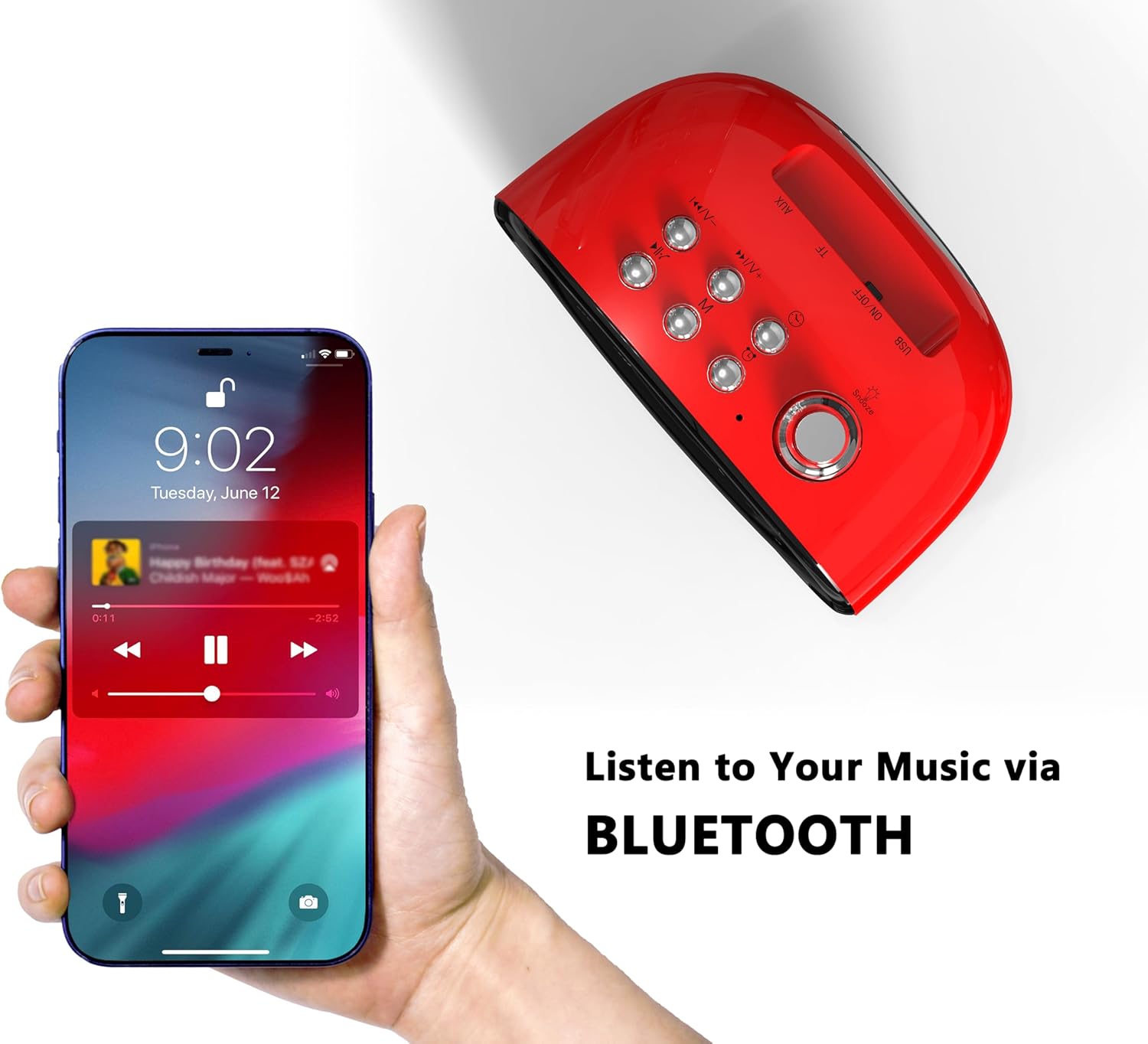 A hand holding a smartphone connected via Bluetooth to the iTOMA Retro Alarm Clock, playing music.