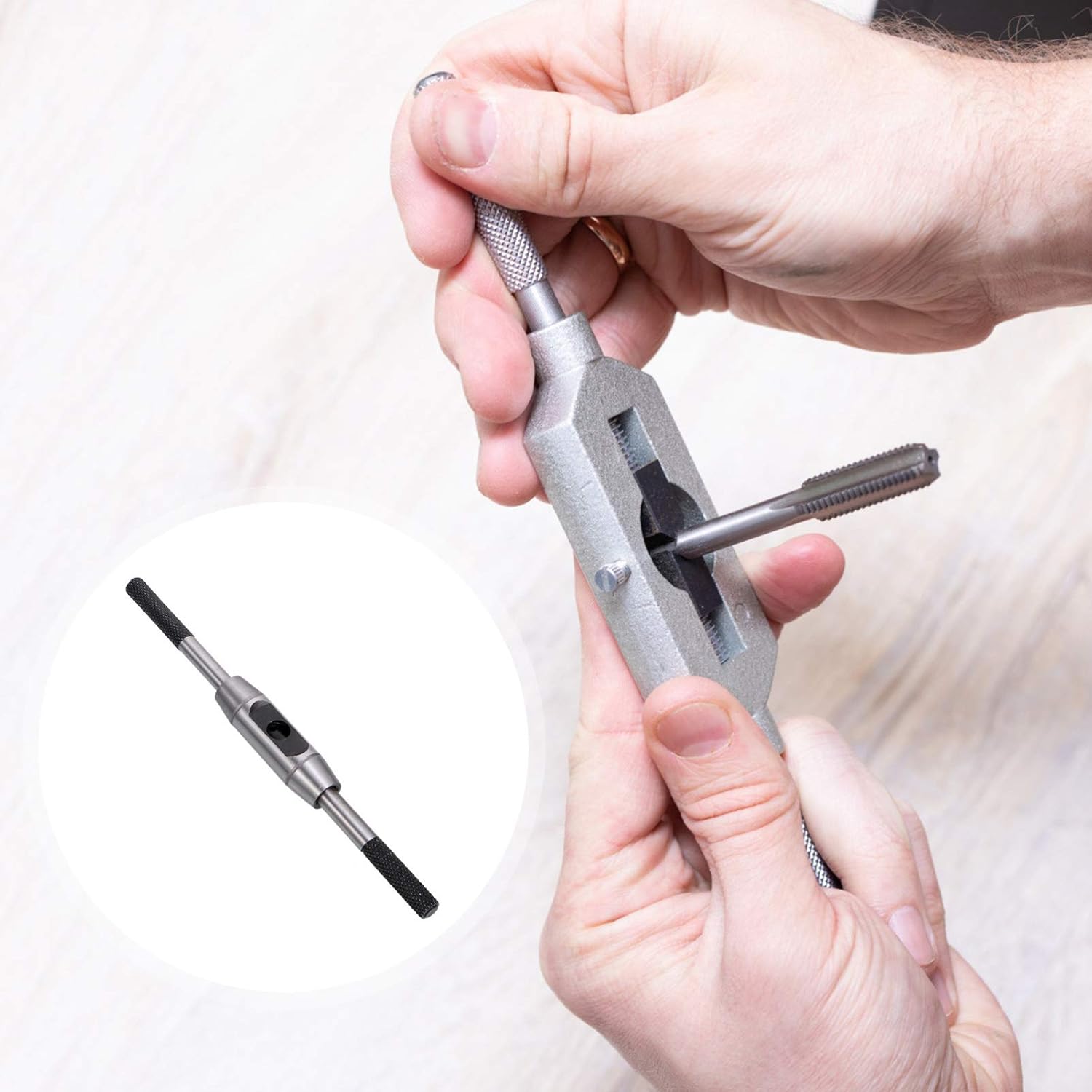 Hands inserting a tap into the tap wrench