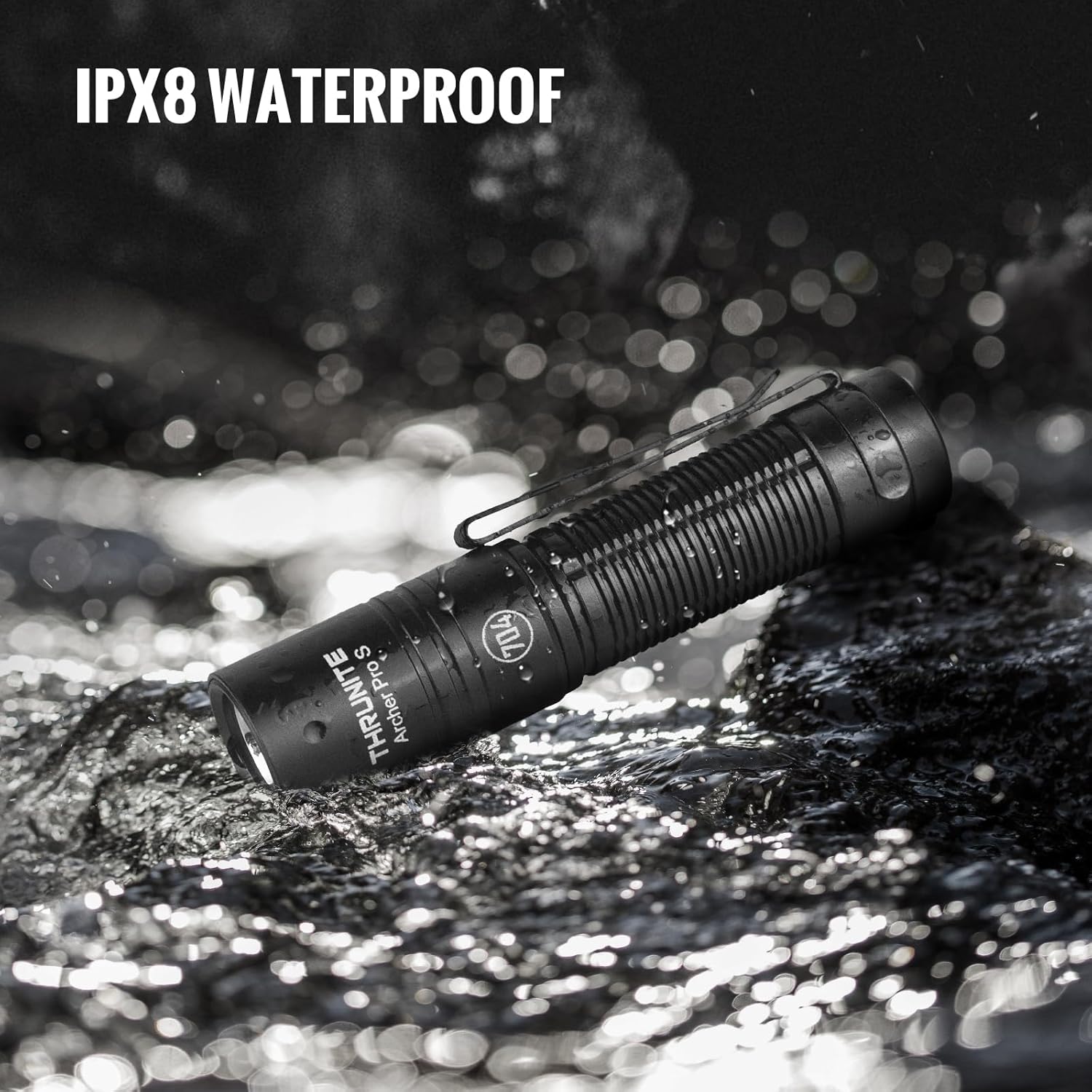 The ThruNite Archer Pro S flashlight lying on wet rocks with water splashing, illustrating its IPX8 waterproof rating.