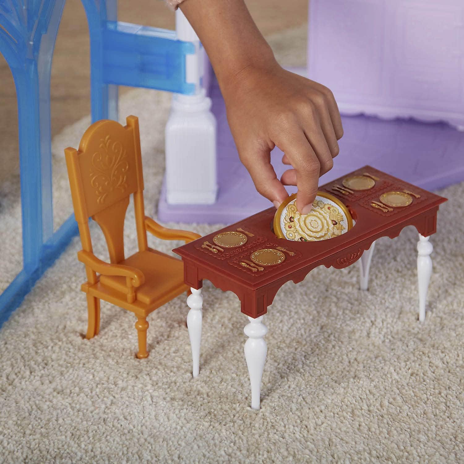 A hand placing an ice gate accessory onto the castle playset.