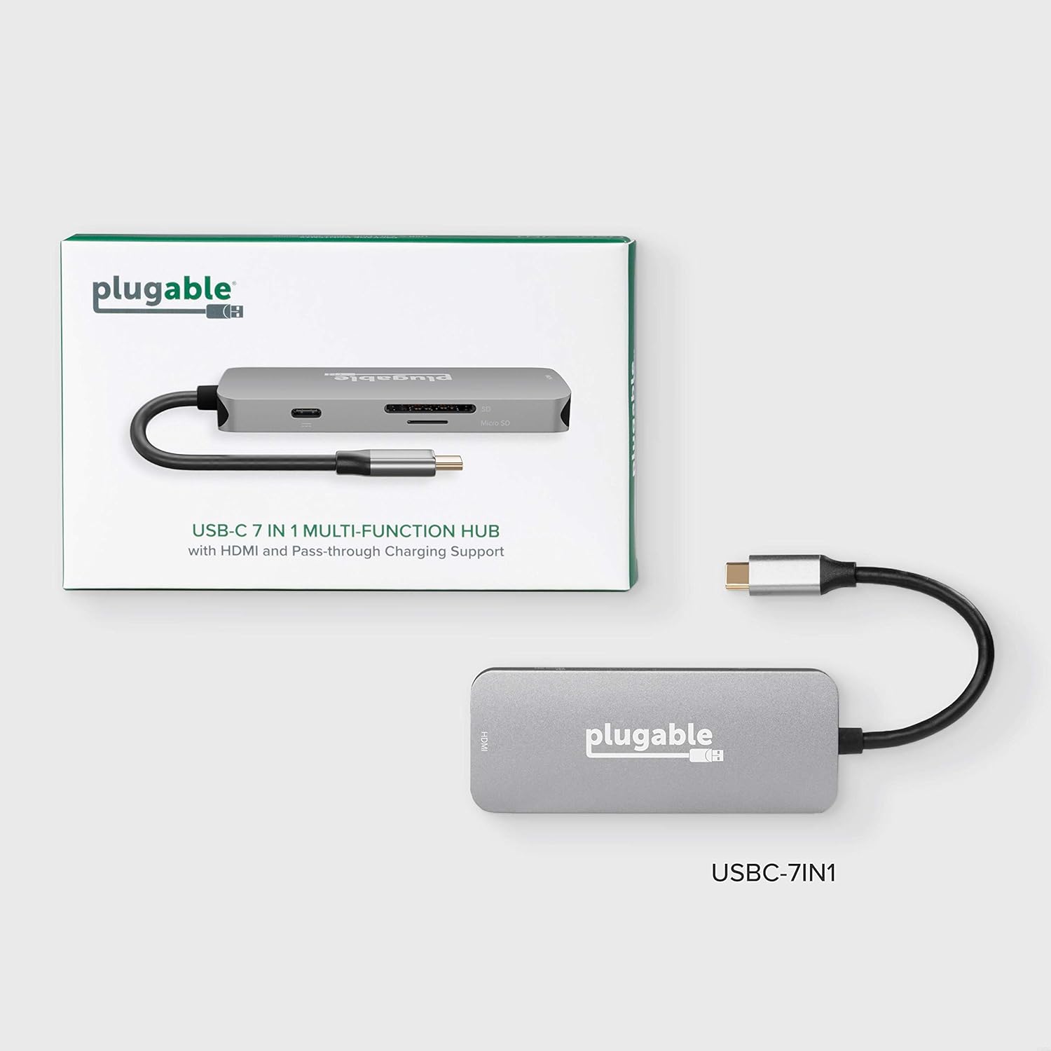 Compact size of the Plugable USB-C 7-in-1 Hub next to a laptop, emphasizing portability.