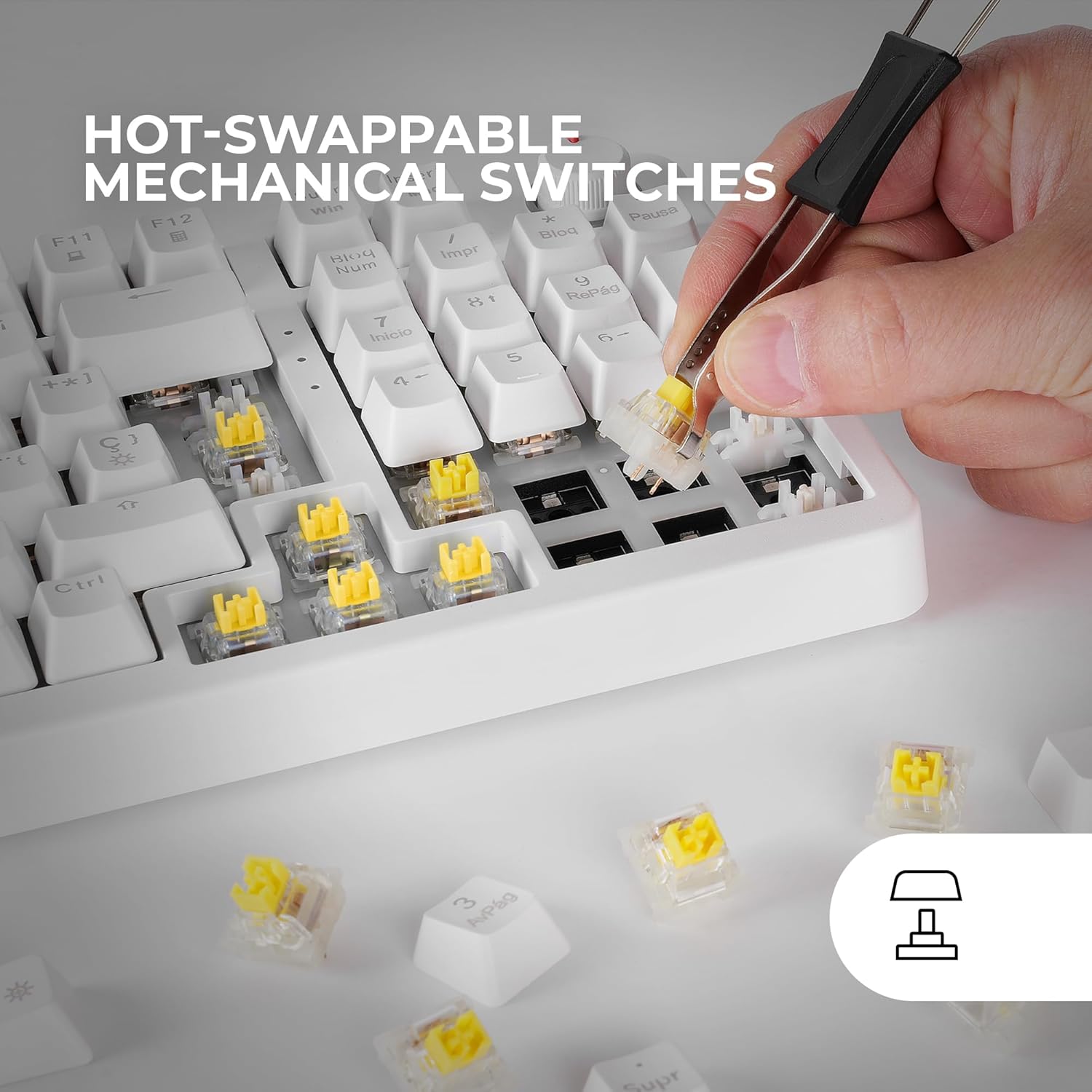 A hand using a switch puller tool to remove a yellow mechanical switch from the Mars Gaming MKPRO keyboard, with spare switches visible.