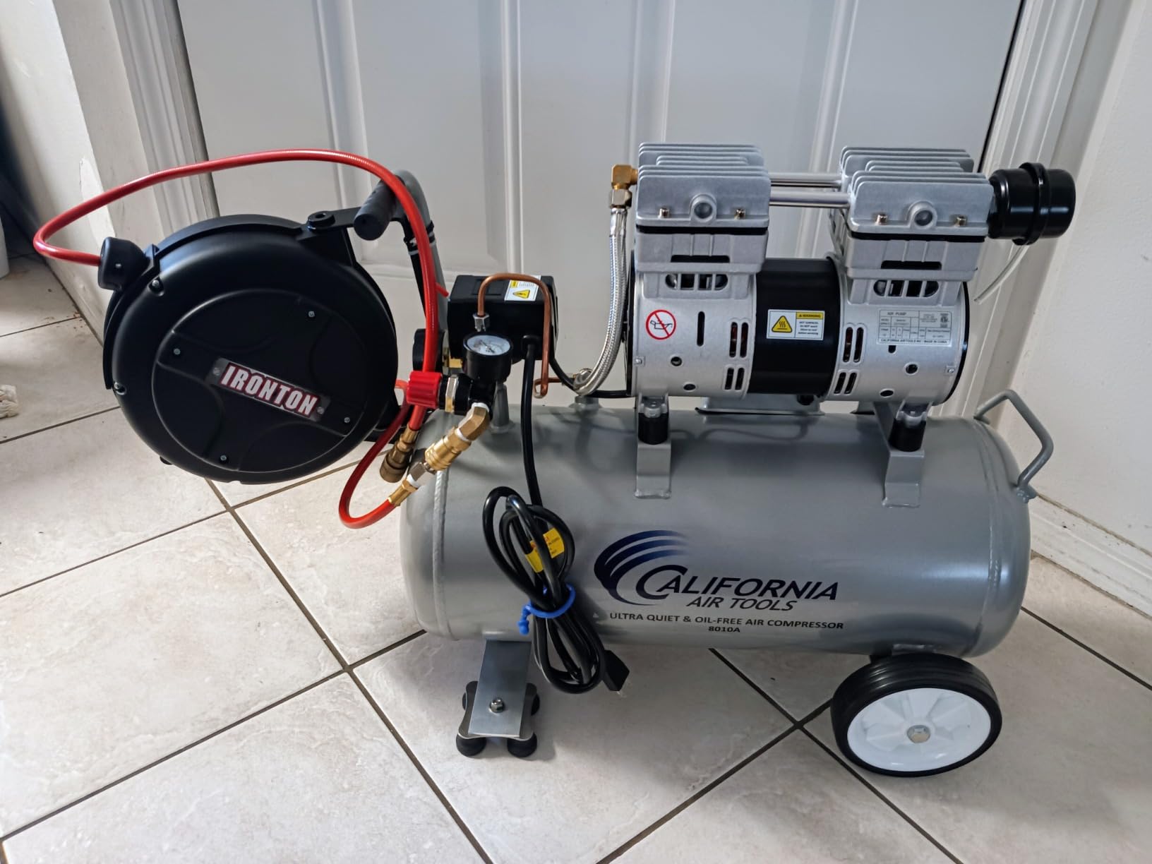 Close-up of a pancake air compressor pressure gauge showing PSI reading
