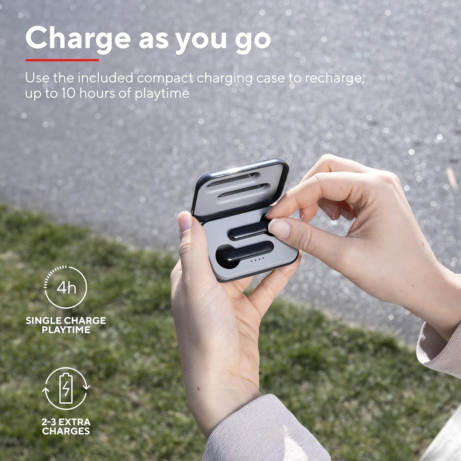 Hands placing a Trust Primo Touch True Wireless Earbud into its charging case, demonstrating the charging process and indicating 4 hours single charge playtime and 2-3 extra charges.