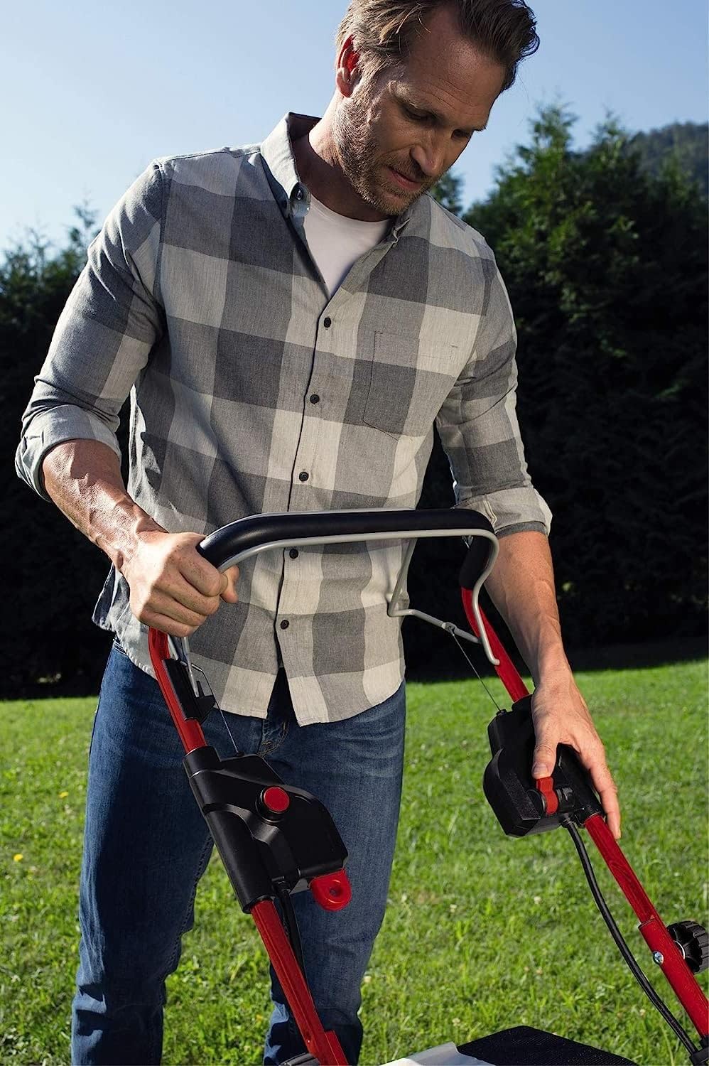 Person operating Einhell cordless lawn mower