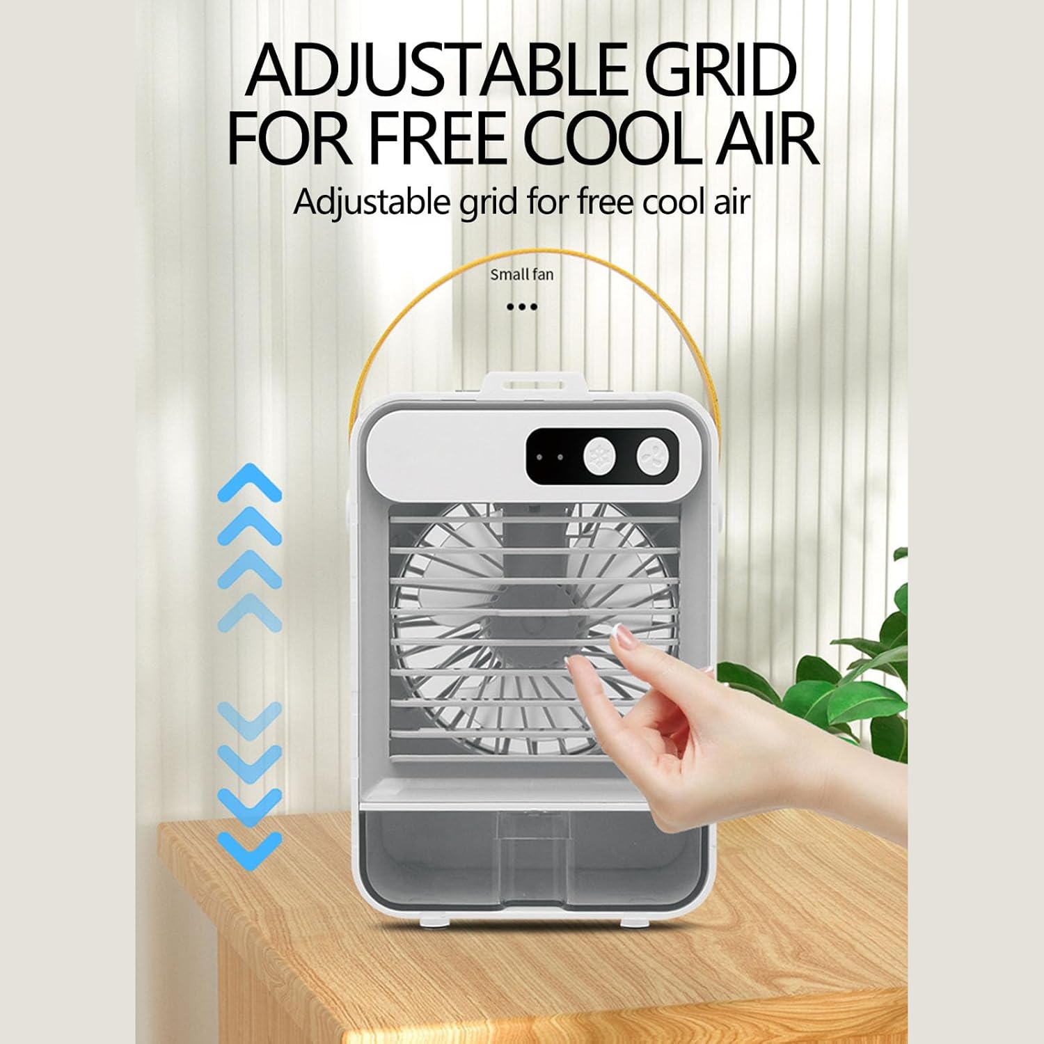 Hand adjusting the front grid of the portable air conditioner to direct airflow.