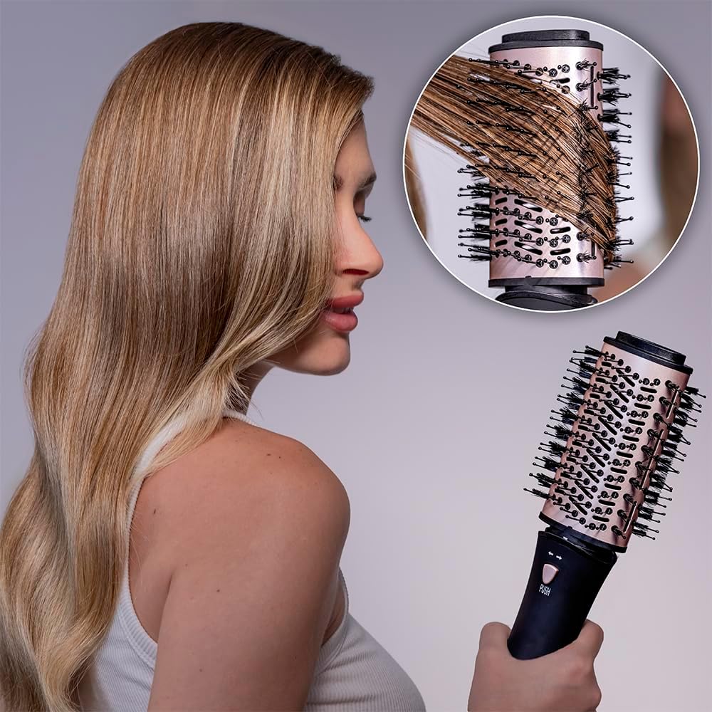 User styling hair with a flat brush attachment for smoothing
