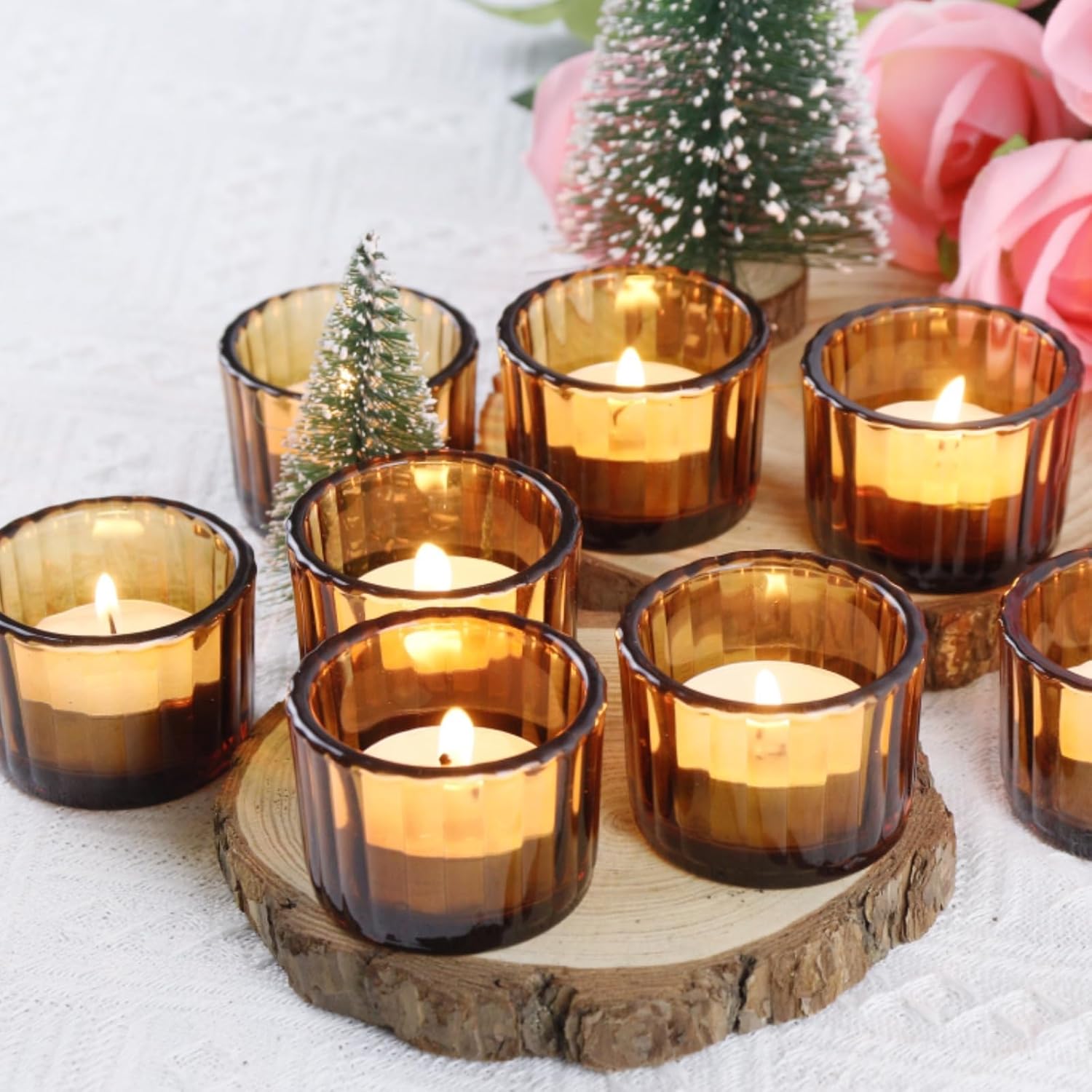 Elegant amber tea candles and candle holders creating a warm ambiance on a table