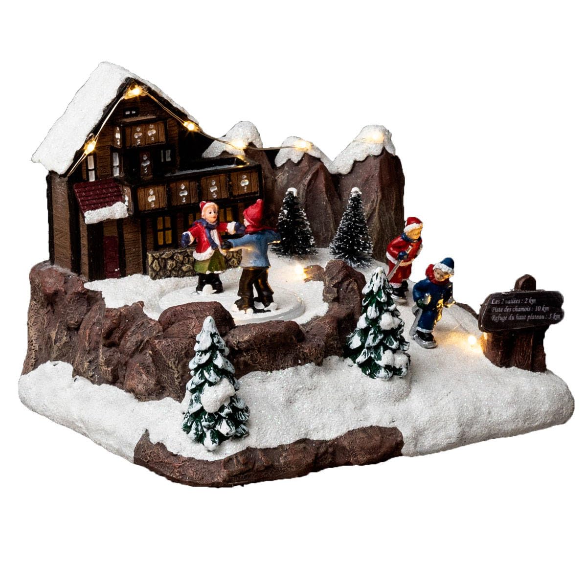 Village de noël magique avec patineur pour raviver vos souvenirs d'enfance