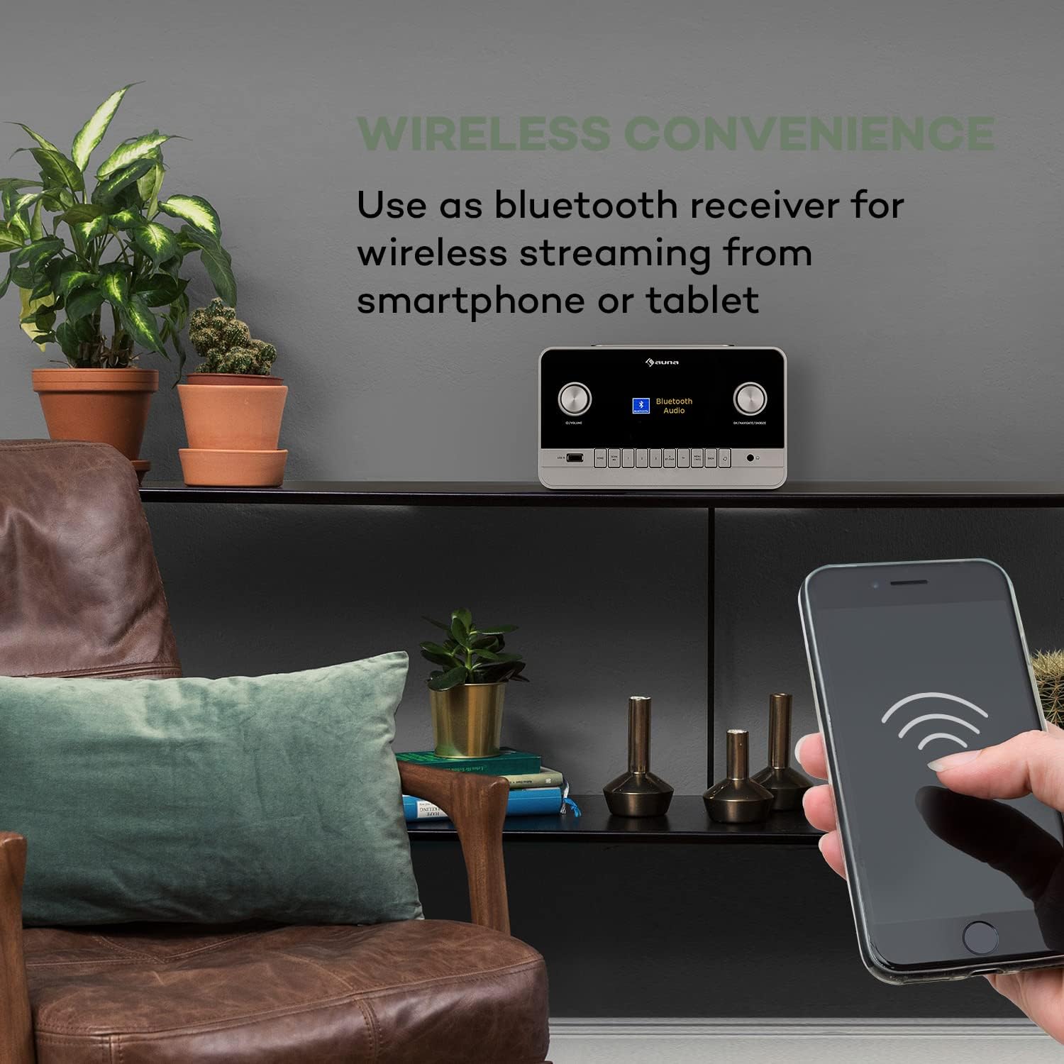 Hand holding a smartphone, wirelessly streaming to the auna Connect 150 MKII