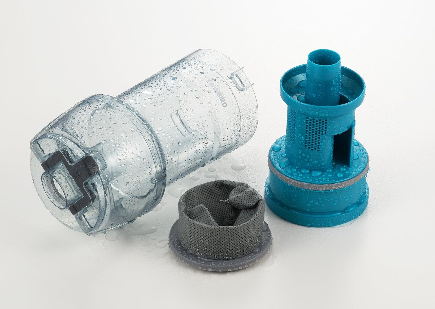 Detached dust case and filter components of the TWINBIRD TC-EA17W, showing they are washable.