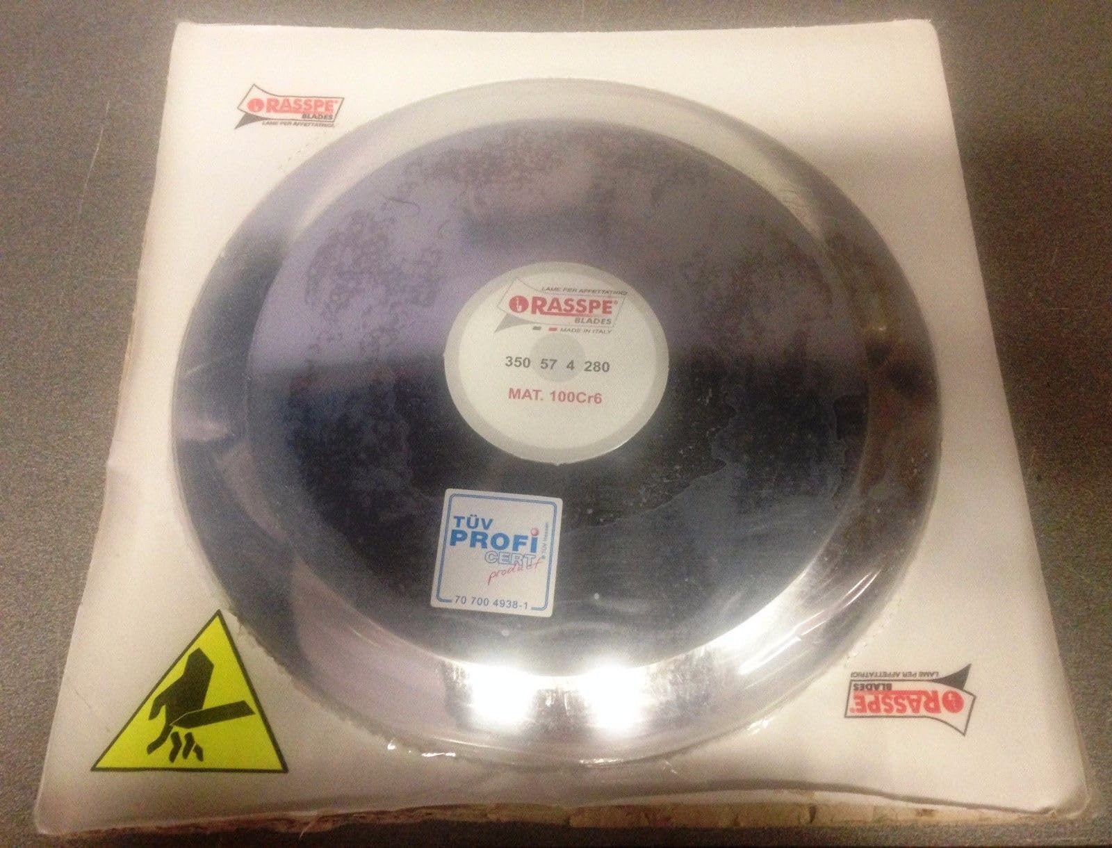 RASSPE Lama per affettatrice 350 mm diametro foro centrale 57 mm - 4 fori fissaggio lama - diametro coprilama 280 mm. Materiale 100Cr6 W1.2067 Made in Italy