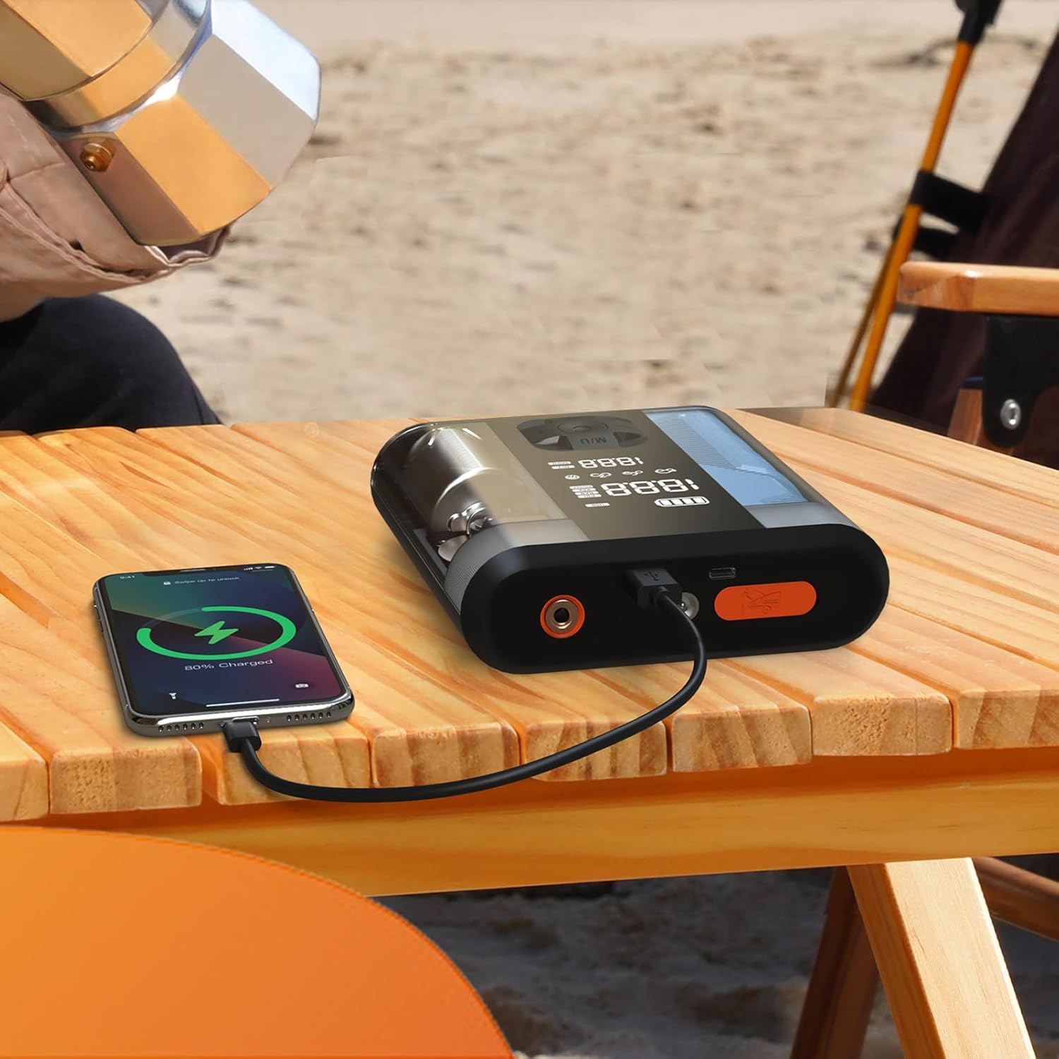 Powerology unit charging a smartphone on a wooden table.