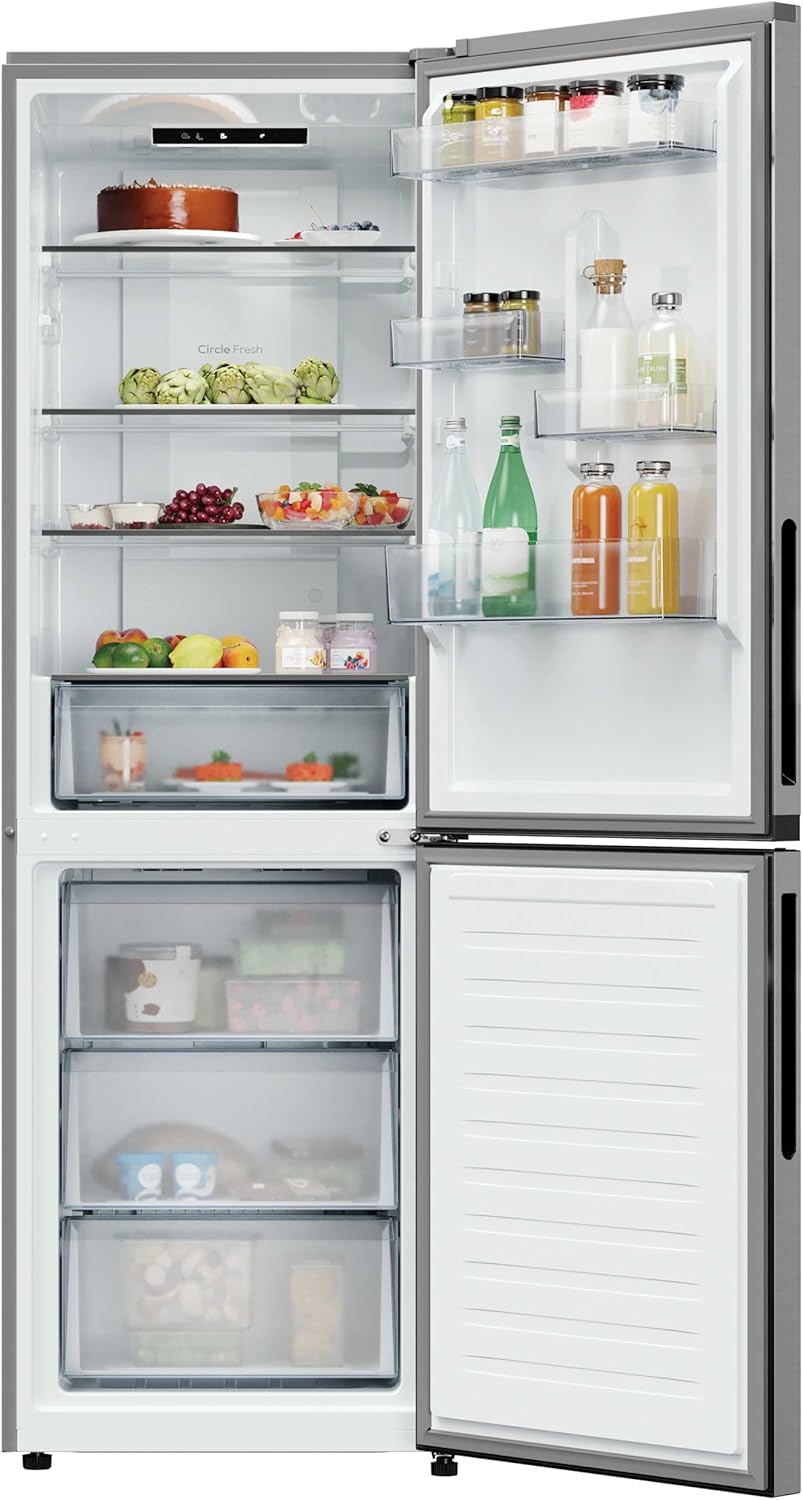 Barrualdea view of the Candy Fresco 300 refrigerator and freezer compartments, showing organized shelves, door bins, and drawers filled with various food items.