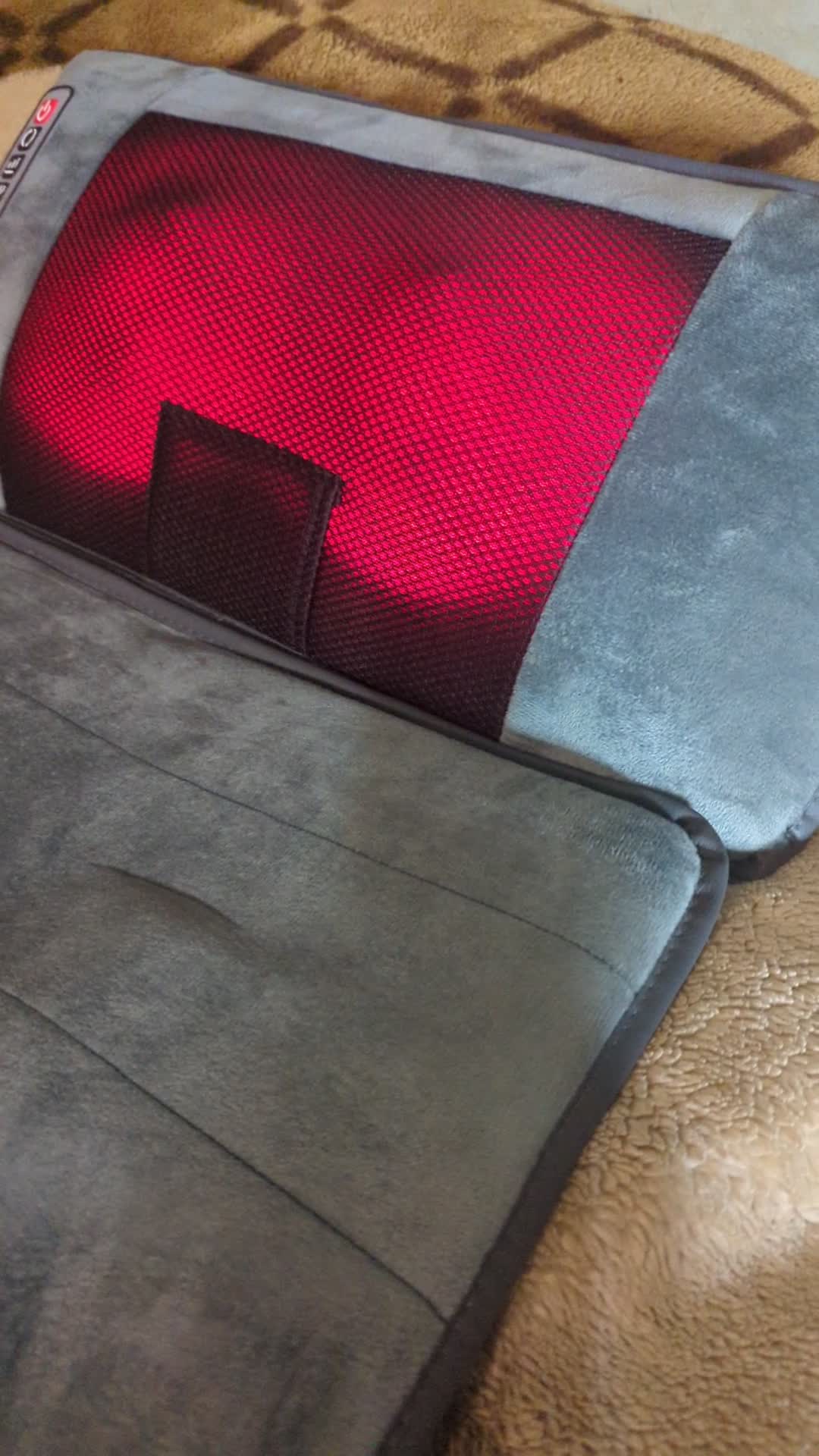 Close-up of the OLIXIS massage mat control panel with various buttons and indicator lights.