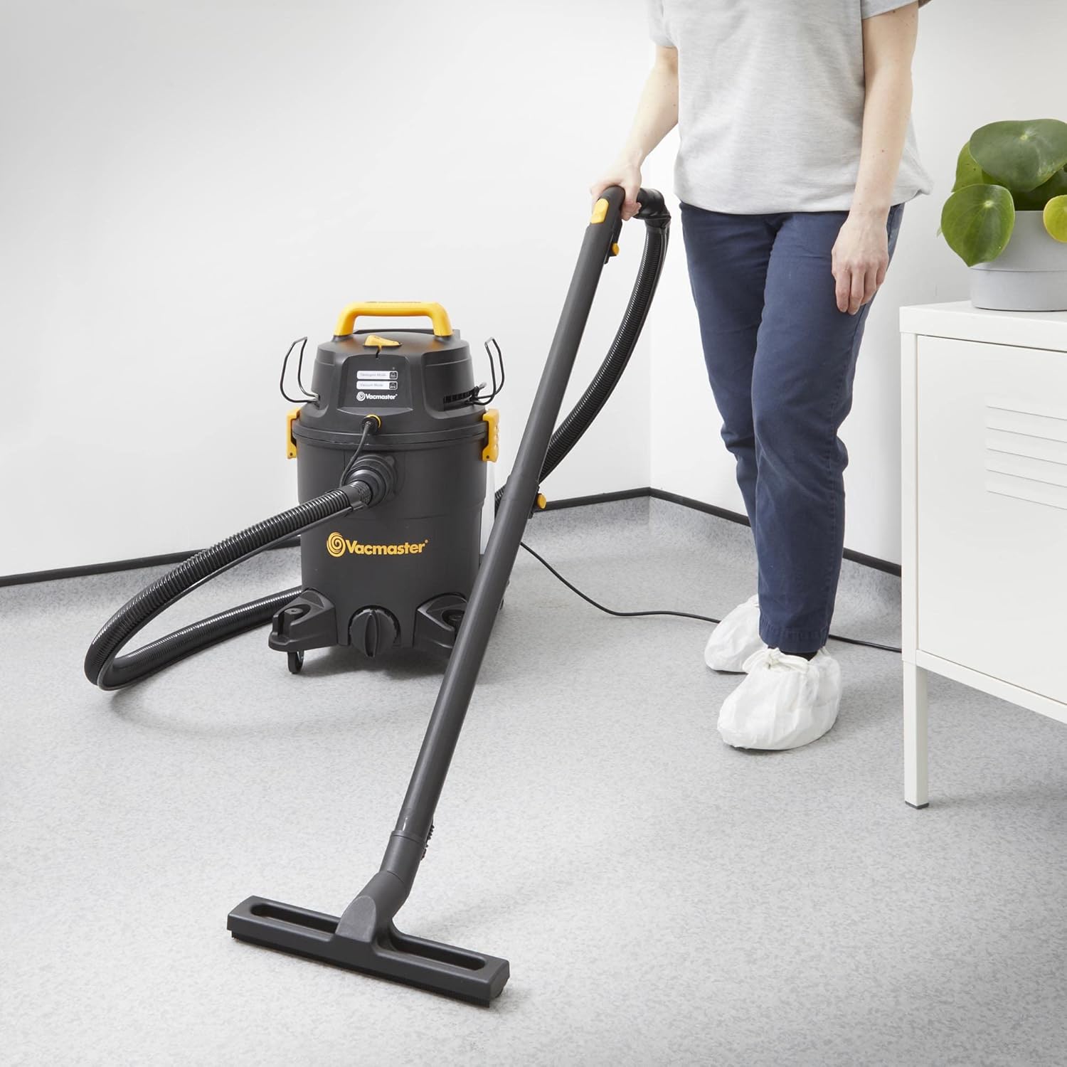 Person dry vacuuming a floor with the Vacmaster VK1323PFR 03