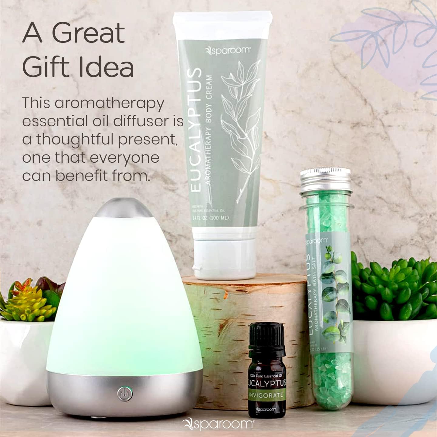 SpaRoom PureMist Mini Diffuser Spa Kit with essential oil, body cream, and bath salts arranged with plants