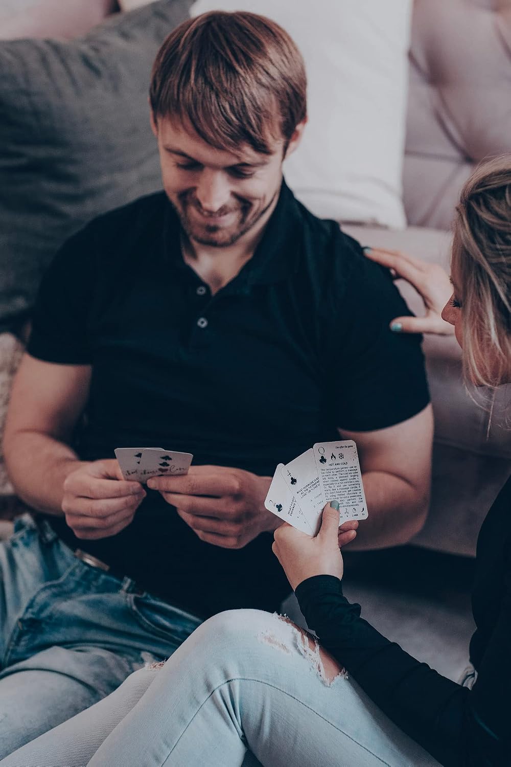 A couple playing the OpenMity 3-in-1 Ultimate Date Night Game with cards in their hands