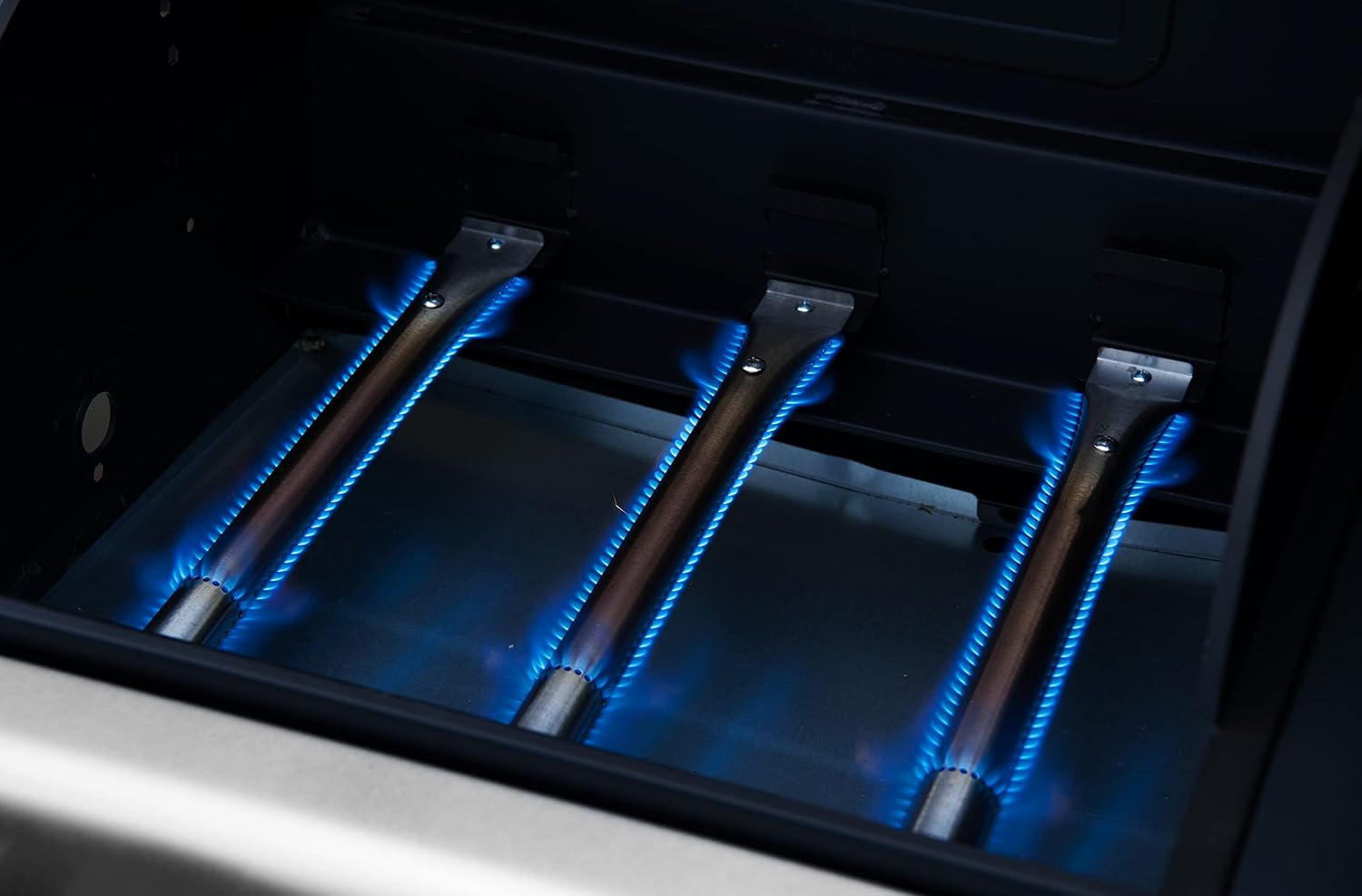 Control panel of the Royal Gourmet ZH3002SC gas grill with three burner knobs and a bottle opener.