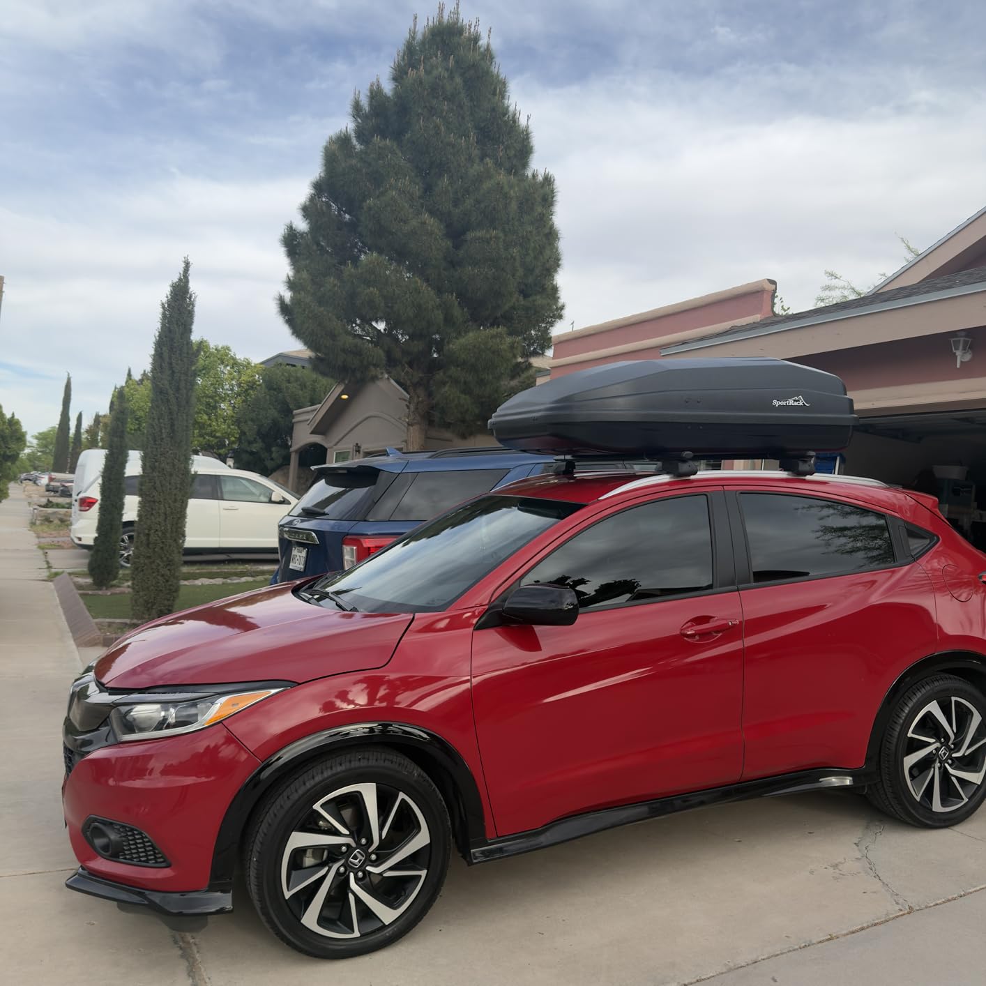 Car packed for a road trip with a waterproof soft rooftop cargo carrier