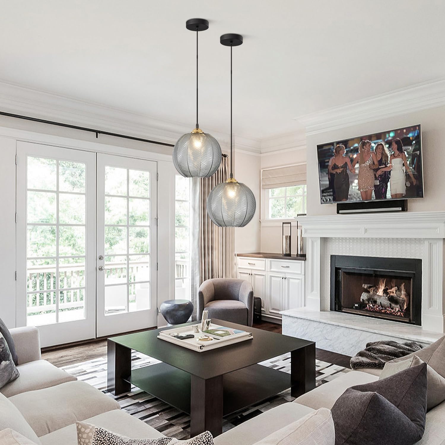 Two KCO Lighting Vintage Smoke Glass Pendant Lights installed in a living room with a fireplace and large windows.