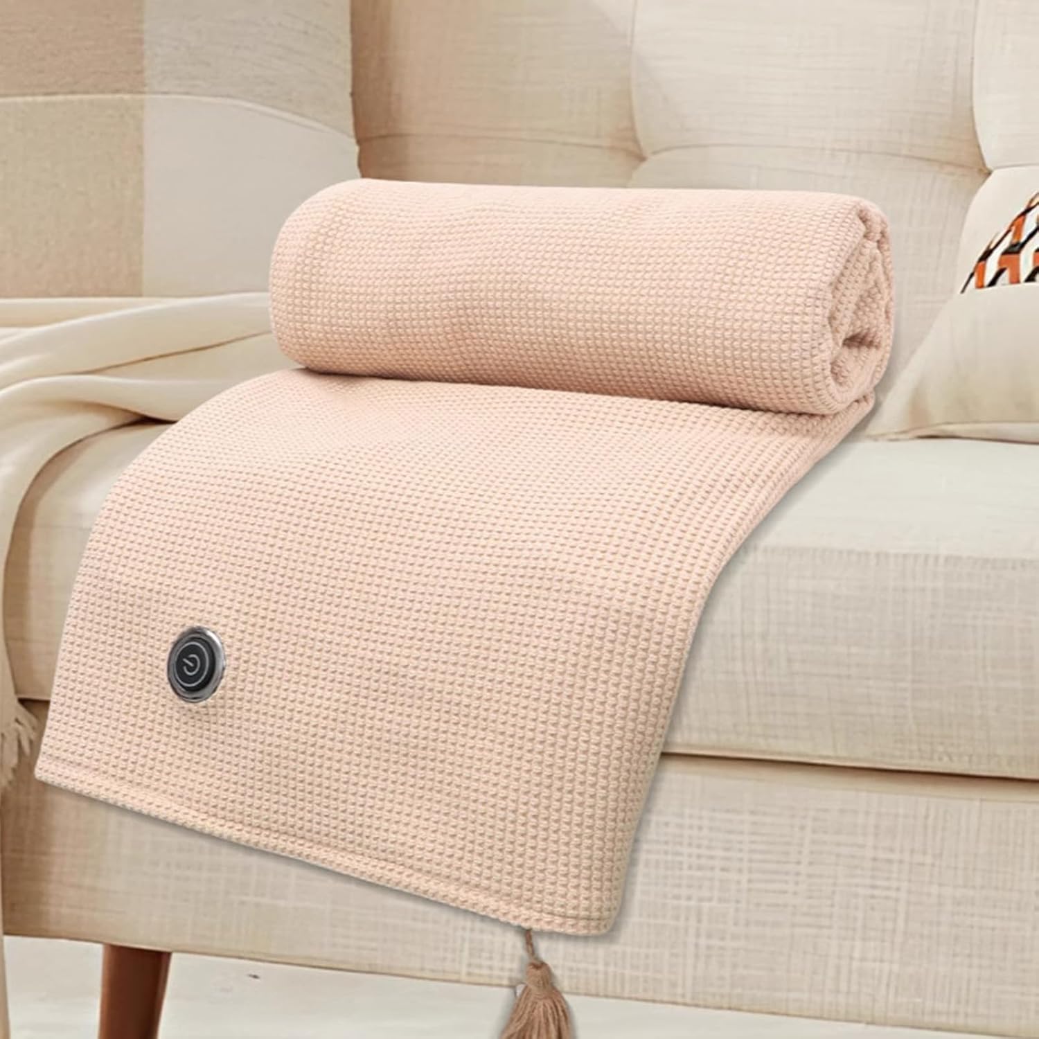 Folded FQFGGYD Portable Heated Blanket on a couch.