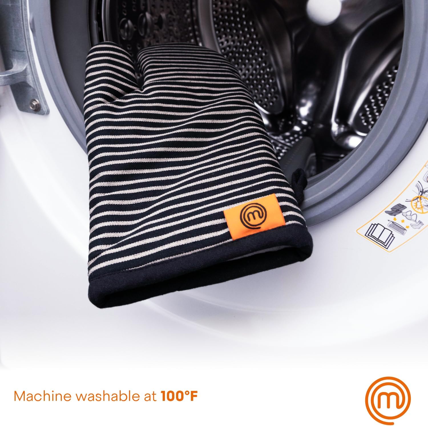 A MasterChef oven mitt inside a washing machine drum.