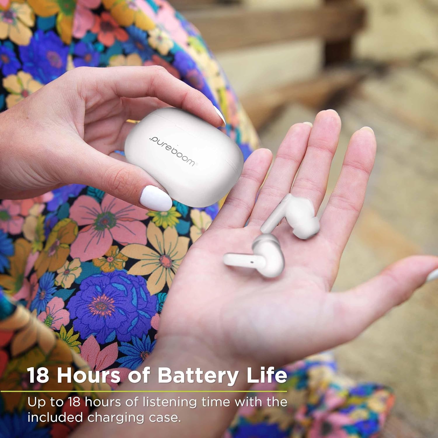 Hand holding PureGear PureBoom Earbuds and charging case, illustrating 18 hours battery life