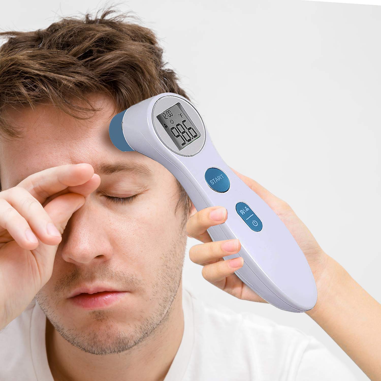 A person using the Care Touch Infrared Forehead Thermometer to take an adult's temperature, holding it near the forehead.