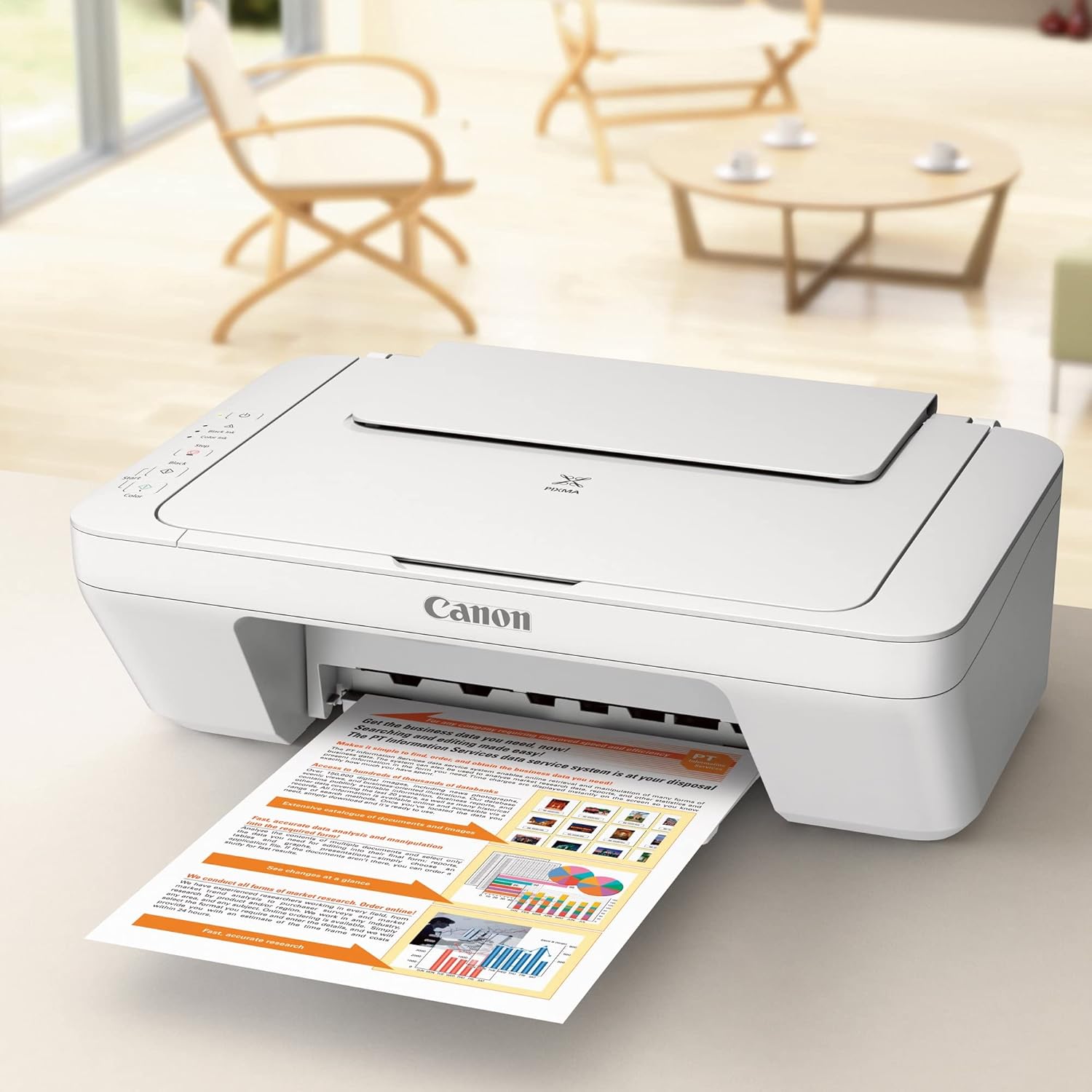 Canon PIXMA MG2522 printer actively printing a document, with paper exiting the front output tray.