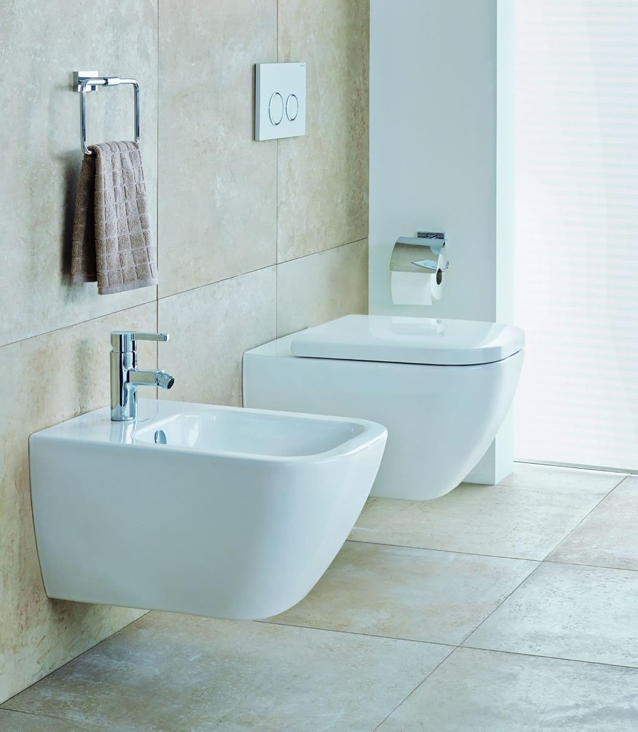 Duravit Happy D.2 wall-mounted toilet installed in a modern bathroom next to a matching wall-mounted bidet.