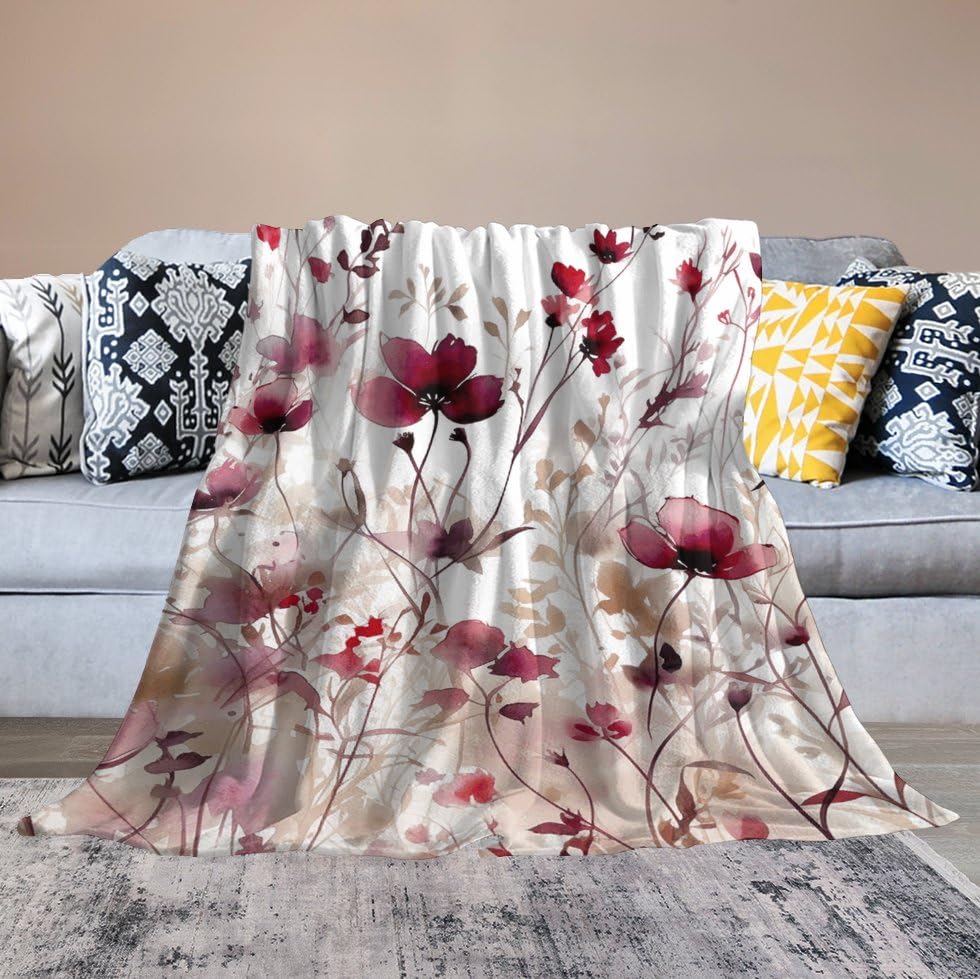 Couverture micro polaire fleurs rouges contre la fraîcheur du salon