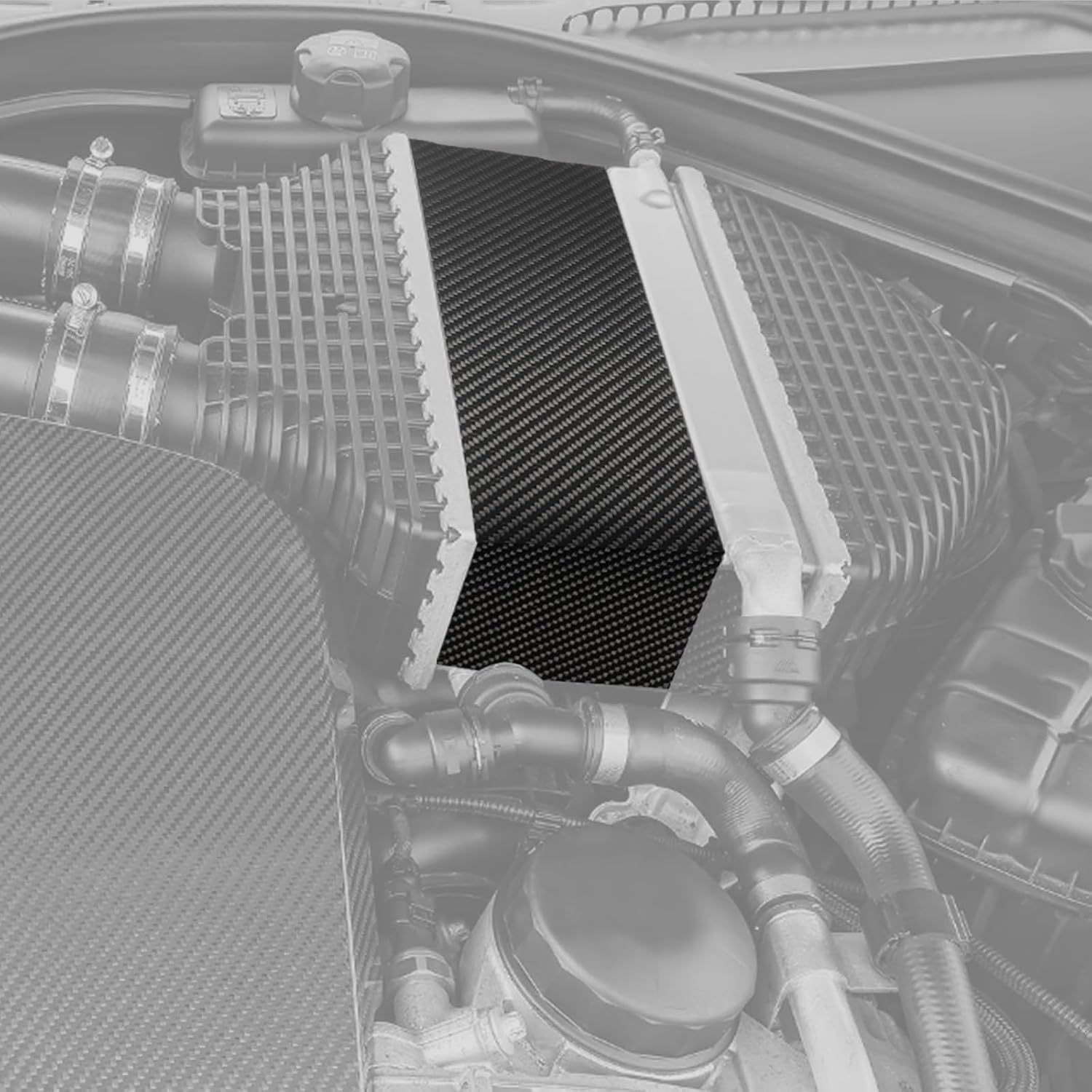 Carbon fiber intercooler cover installed on an S55 engine.