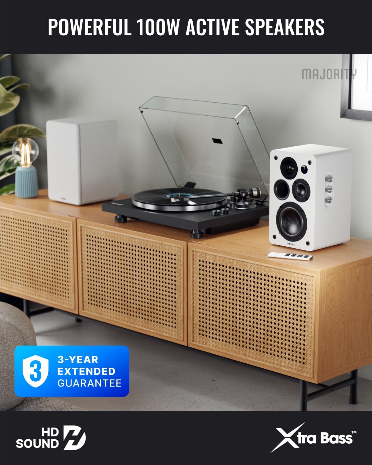 Majority D100X speakers set up on a wooden cabinet with a turntable