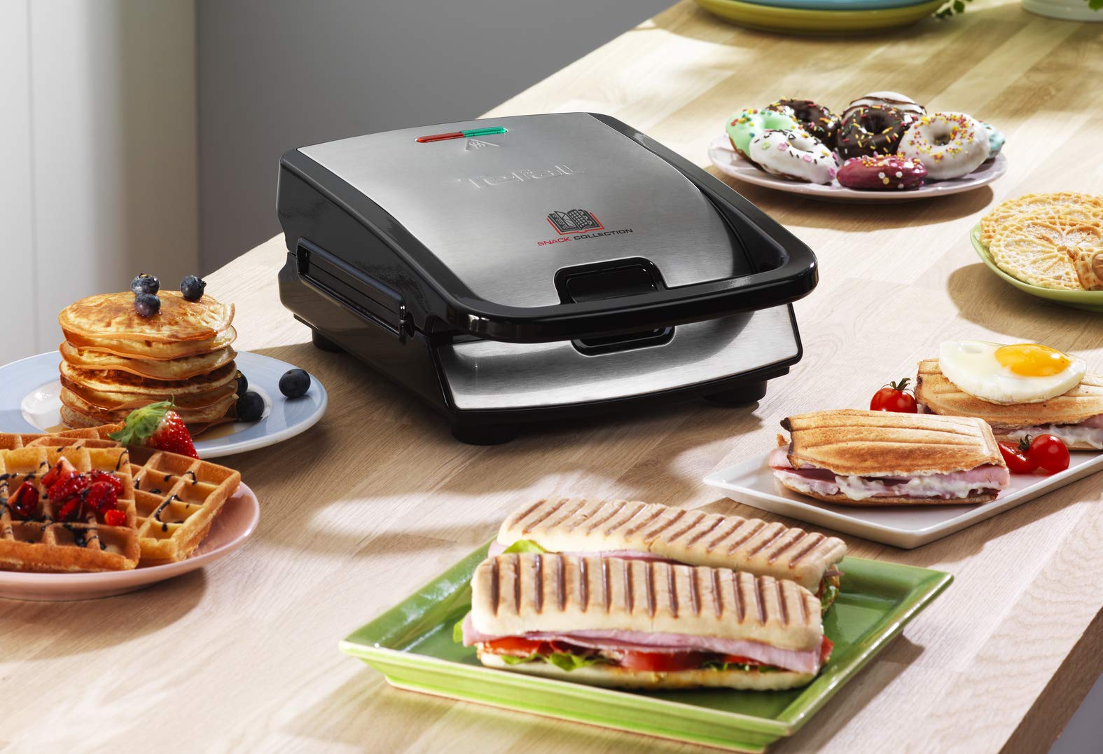 A variety of snacks including waffles, pancakes, sandwiches, and donuts prepared using the Tefal Snack Collection SW854D.