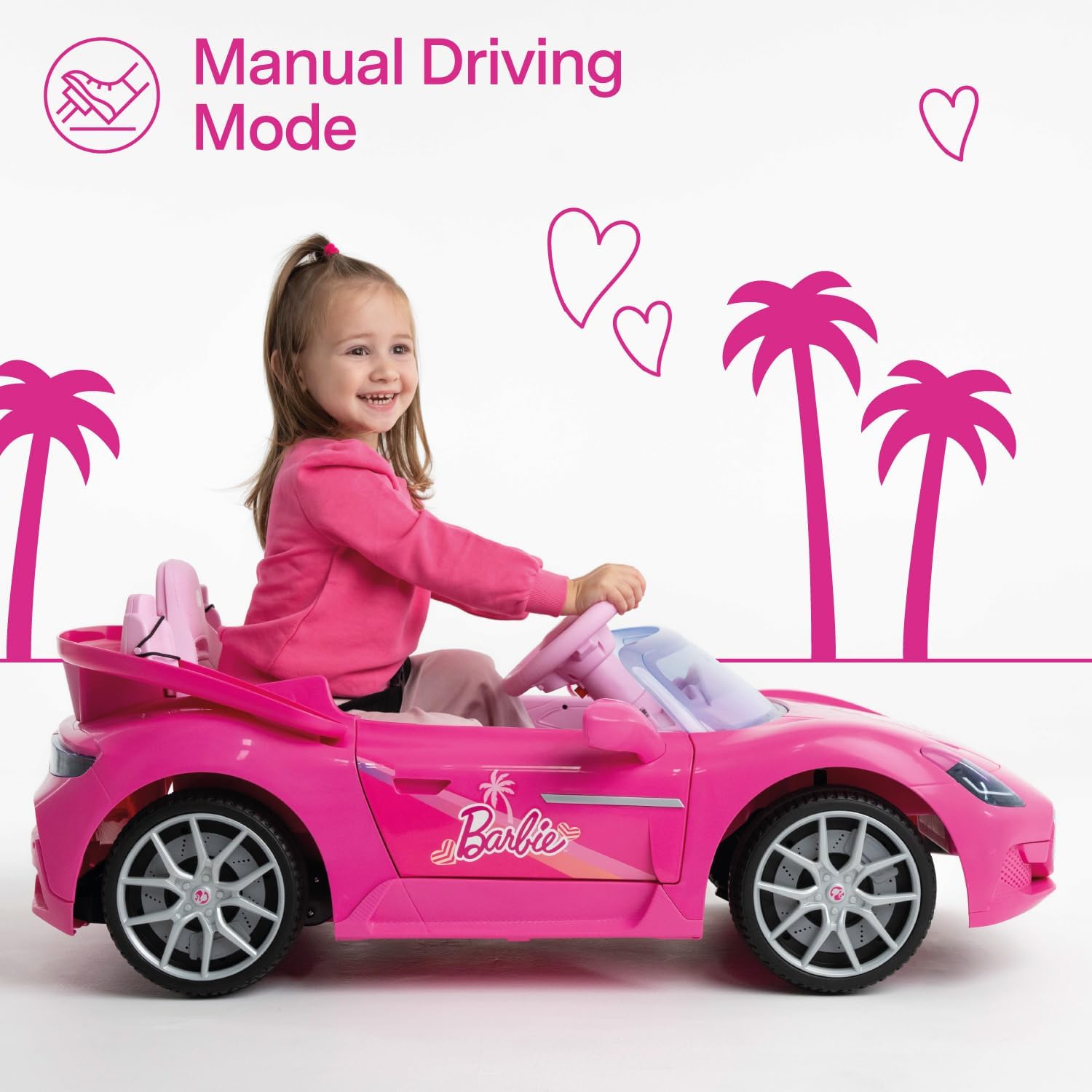 A young child happily driving the Barbie Electric Sports Car in manual mode.
