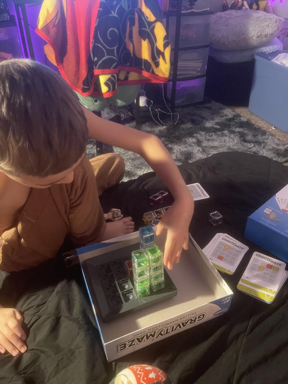 Close up view of the Gravity Maze challenge cards and various tower pieces showing the different heights and configurations