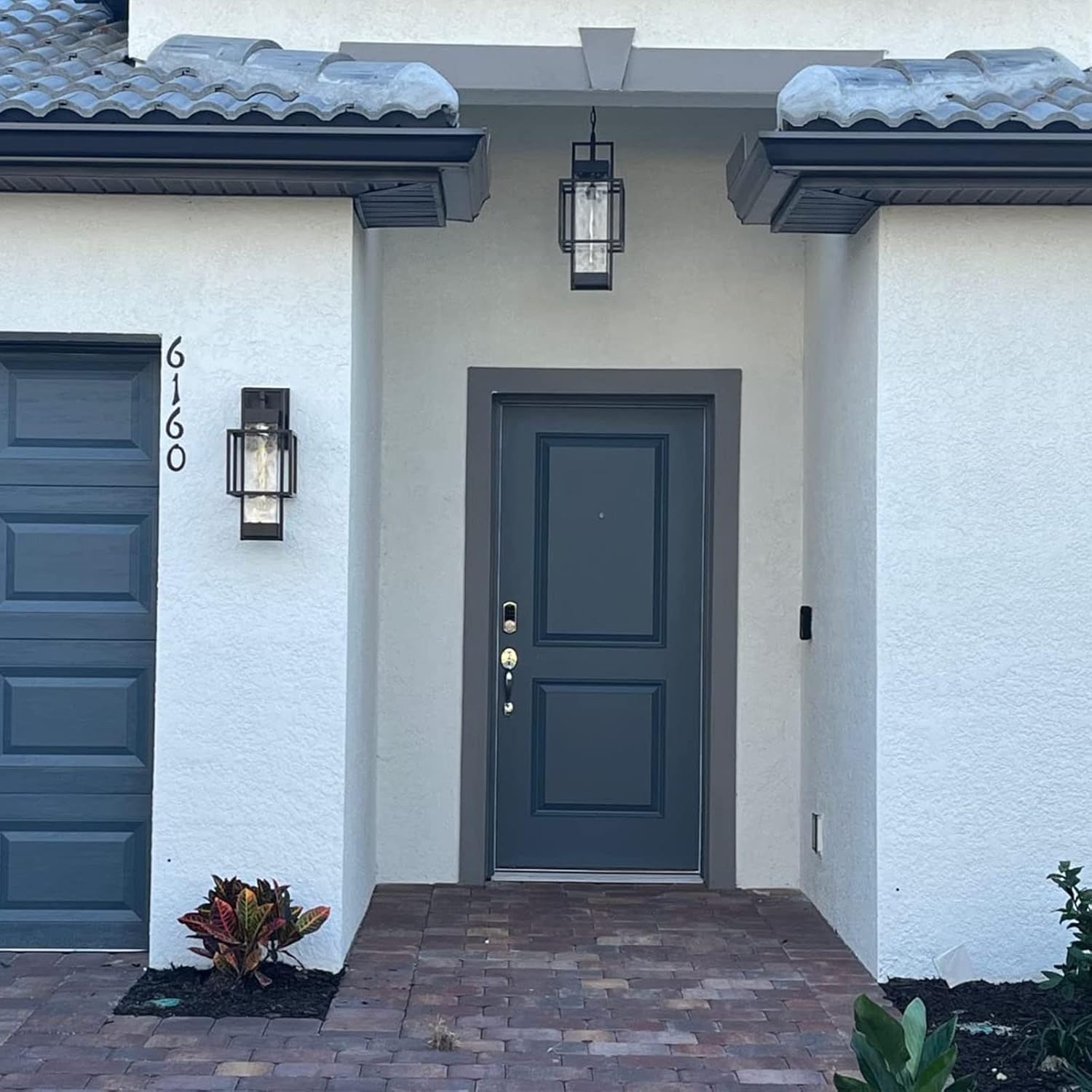 Outdoor wall light installed on a house next to a door