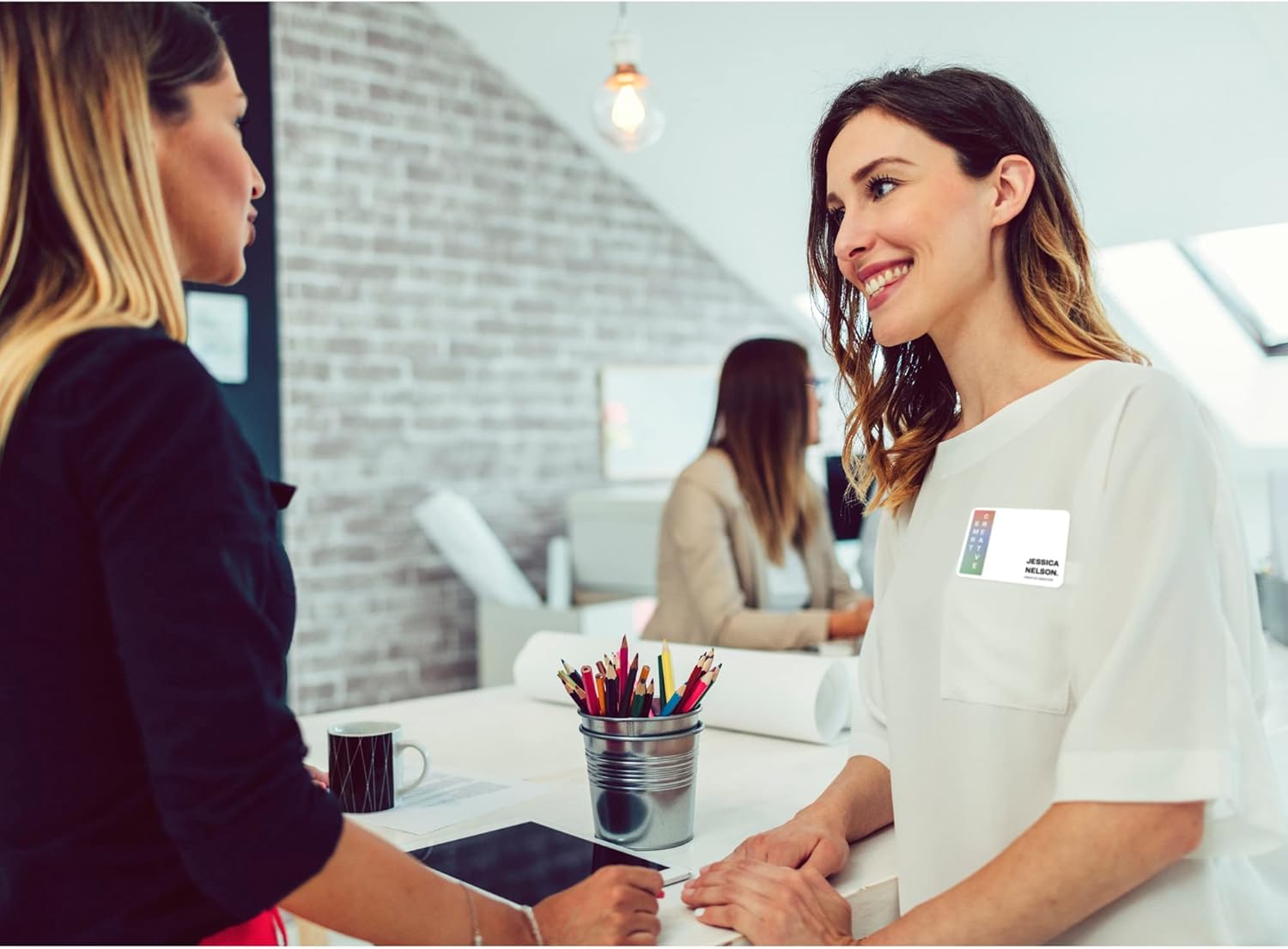 Two individuals interacting, one wearing an Avery name badge
