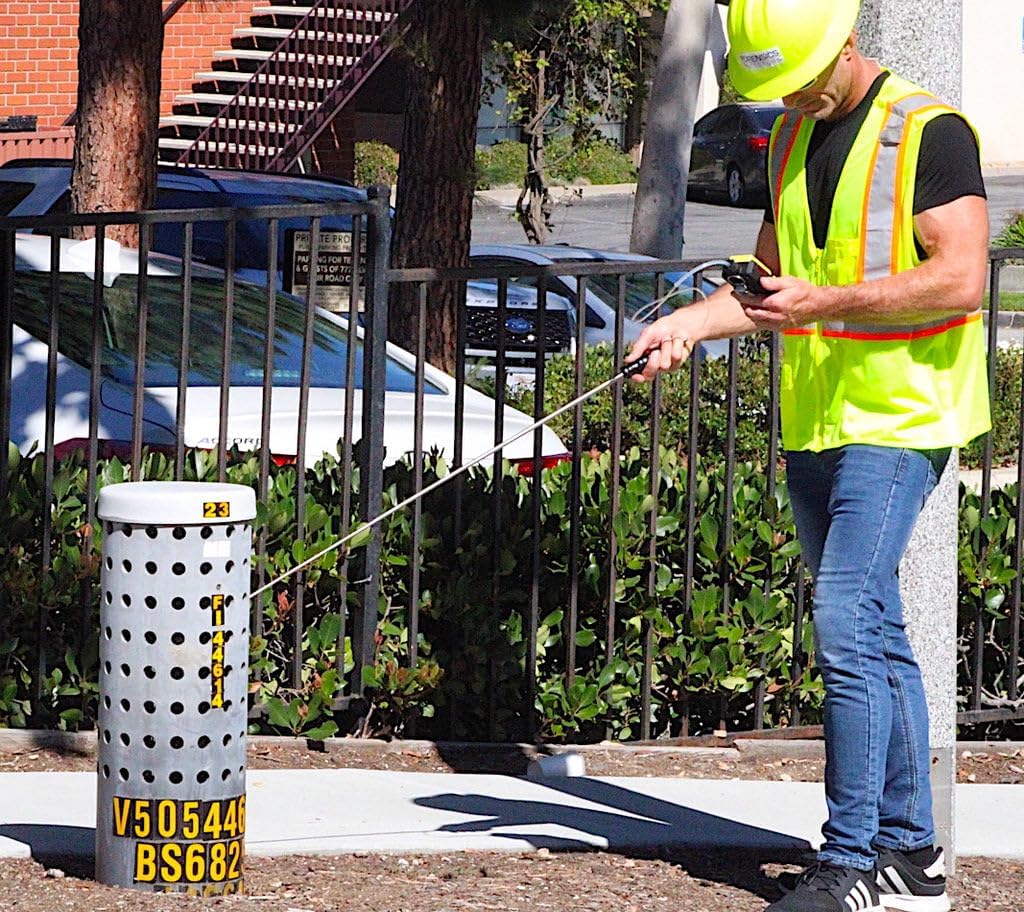 User operating the FORENSICS DETECTORS FD-600-CO2 Carbon Dioxide Analyzer with the telescopic probe for leak detection