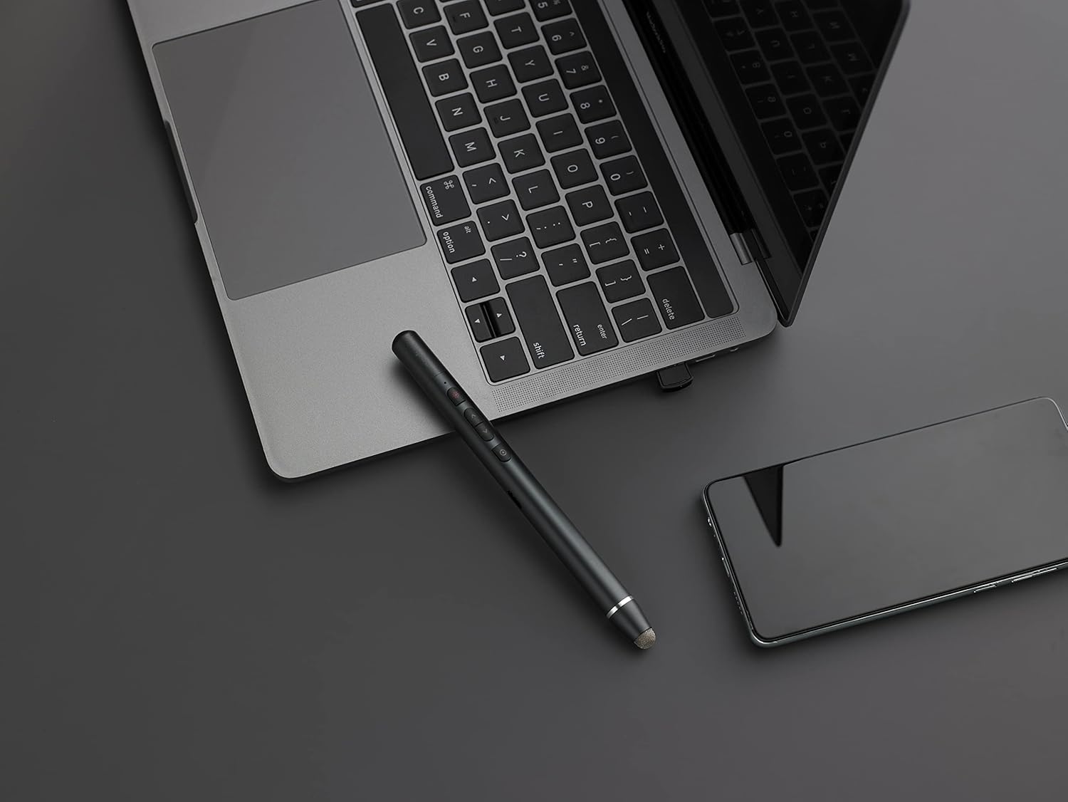 RAPOO XR200 Wireless Presenter next to a laptop keyboard