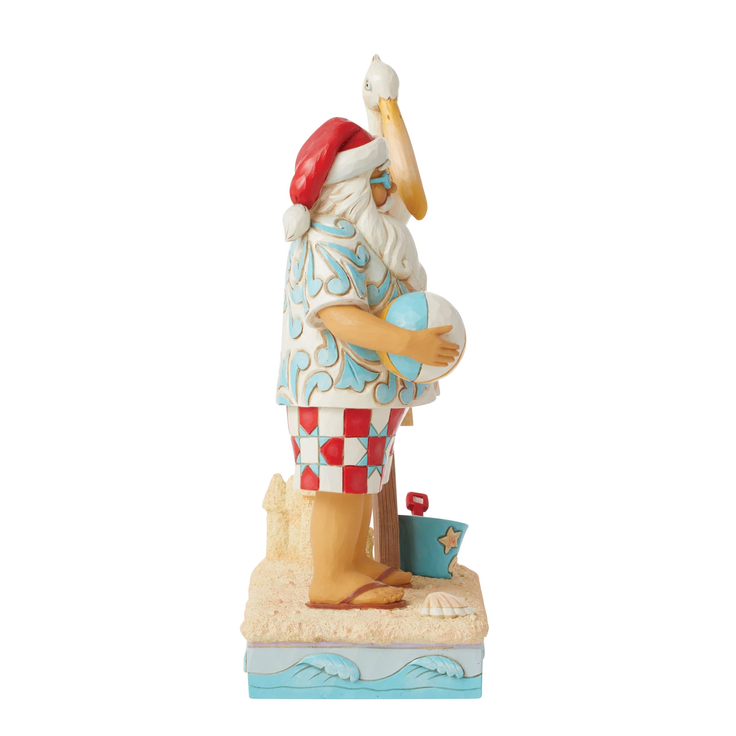 Enesco Jim Shore Heartwood Creek Figurine de Père Noël côtier avec panneaux de plage et pélican - Pierre en résine peinte à la main - Figurine de Père Noël de collection - Décoration d'intérieur - 24