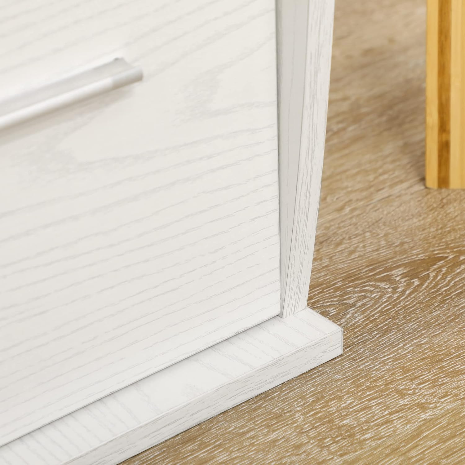 Close-up of the open compartments under the desktop, supported by aluminum poles, with books stored inside.