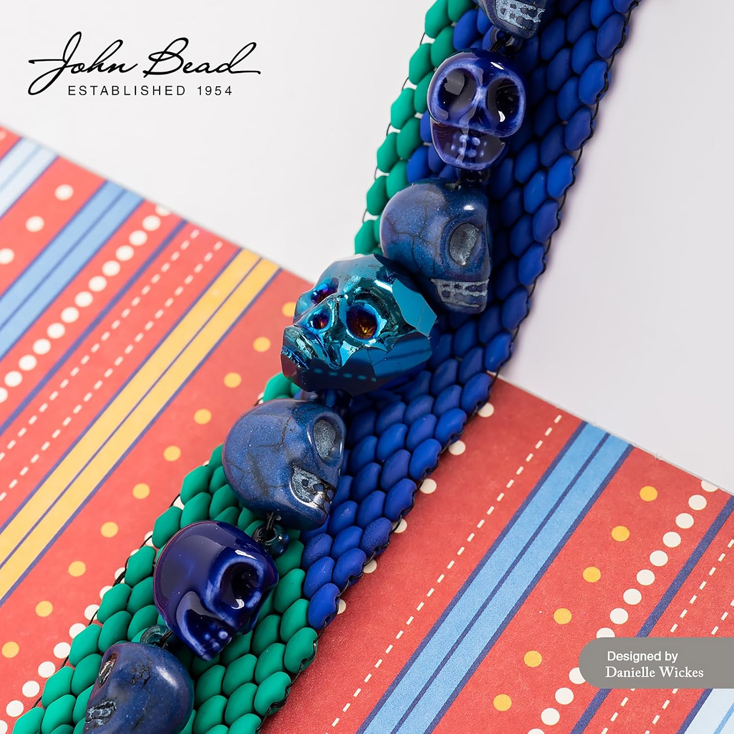 John Bead 33 Assorted Sized Skulls Bead Strand 6.5in. Strand Orange