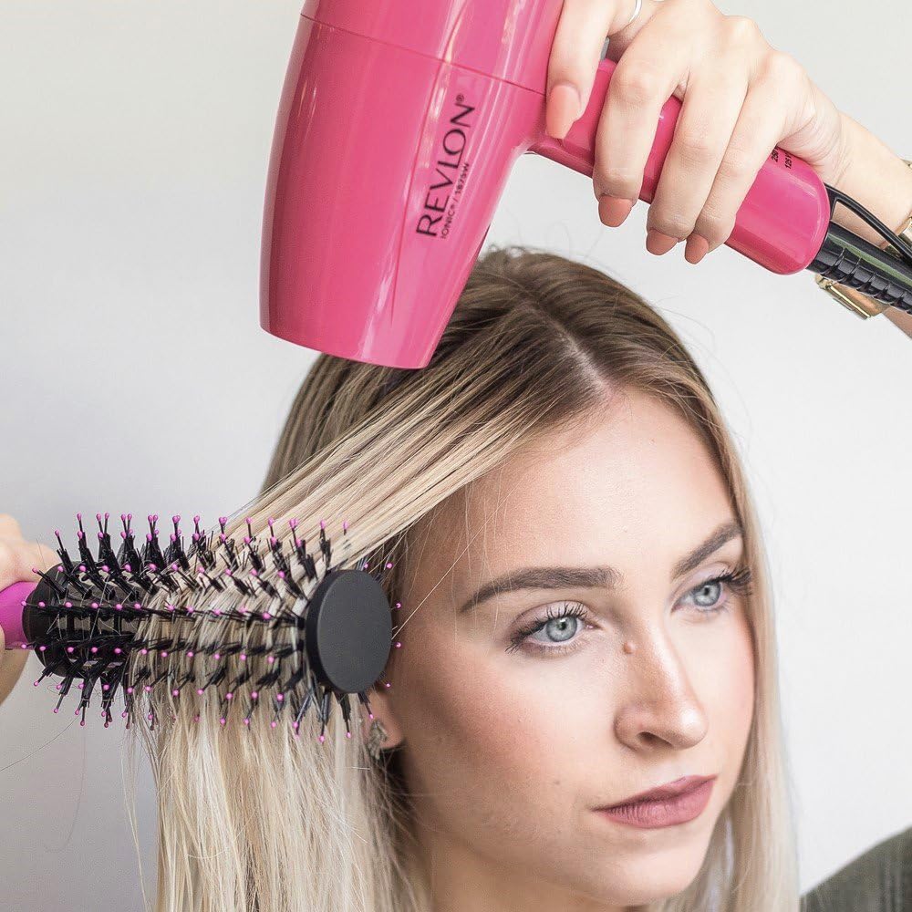 Woman using Revlon RVDR5010 dryer with a round brush