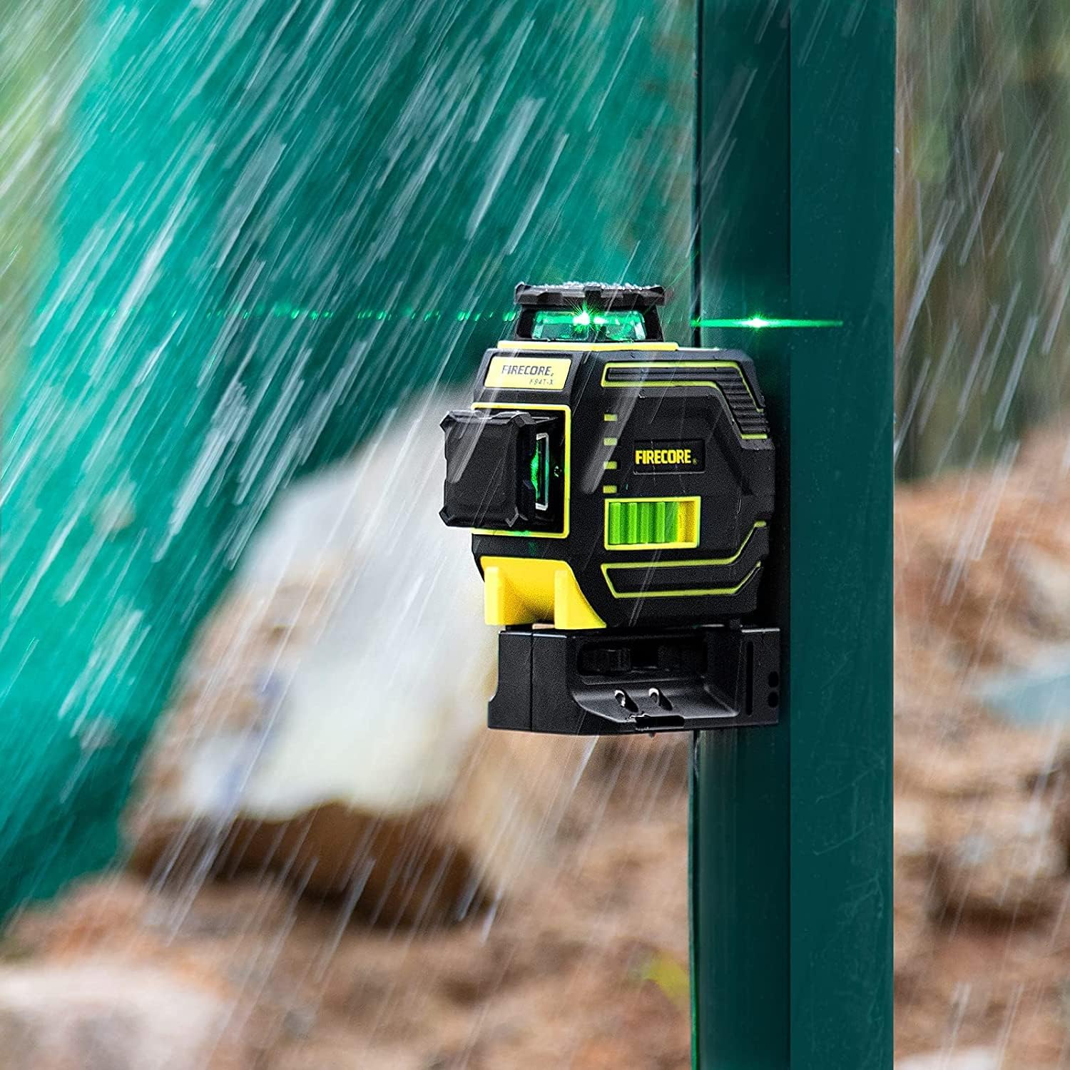 Firecore F94T-XG Laser Level being used in rainy conditions, demonstrating its rugged design.