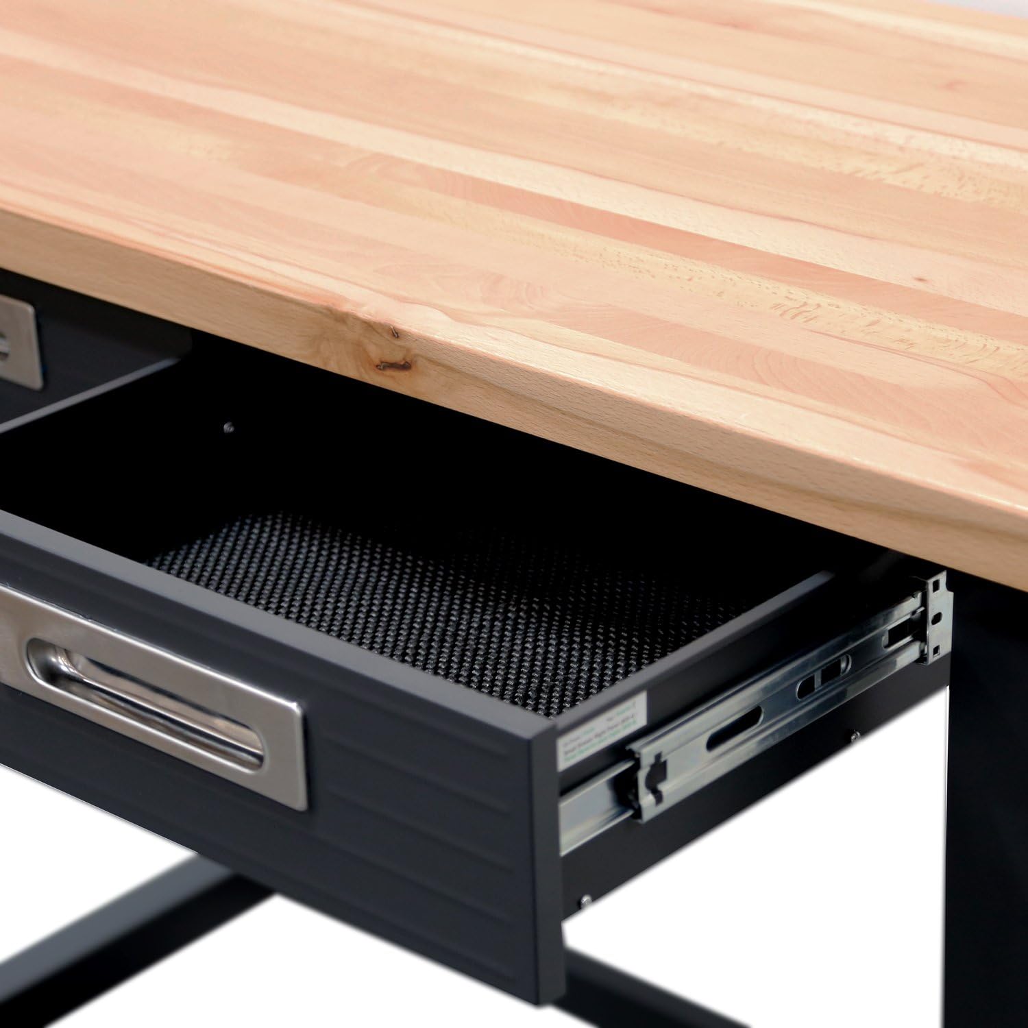 An open drawer of the workbench showing the non-slip liner and ball-bearing slides.