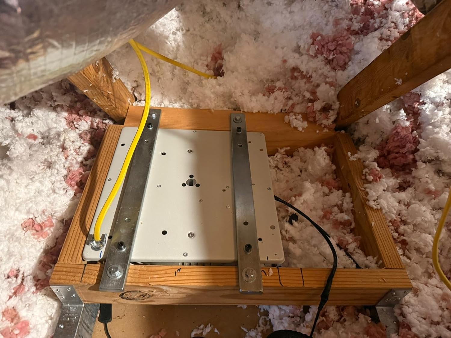 อื่น view of the chandelier lift system installed in an attic, showing wiring connections.