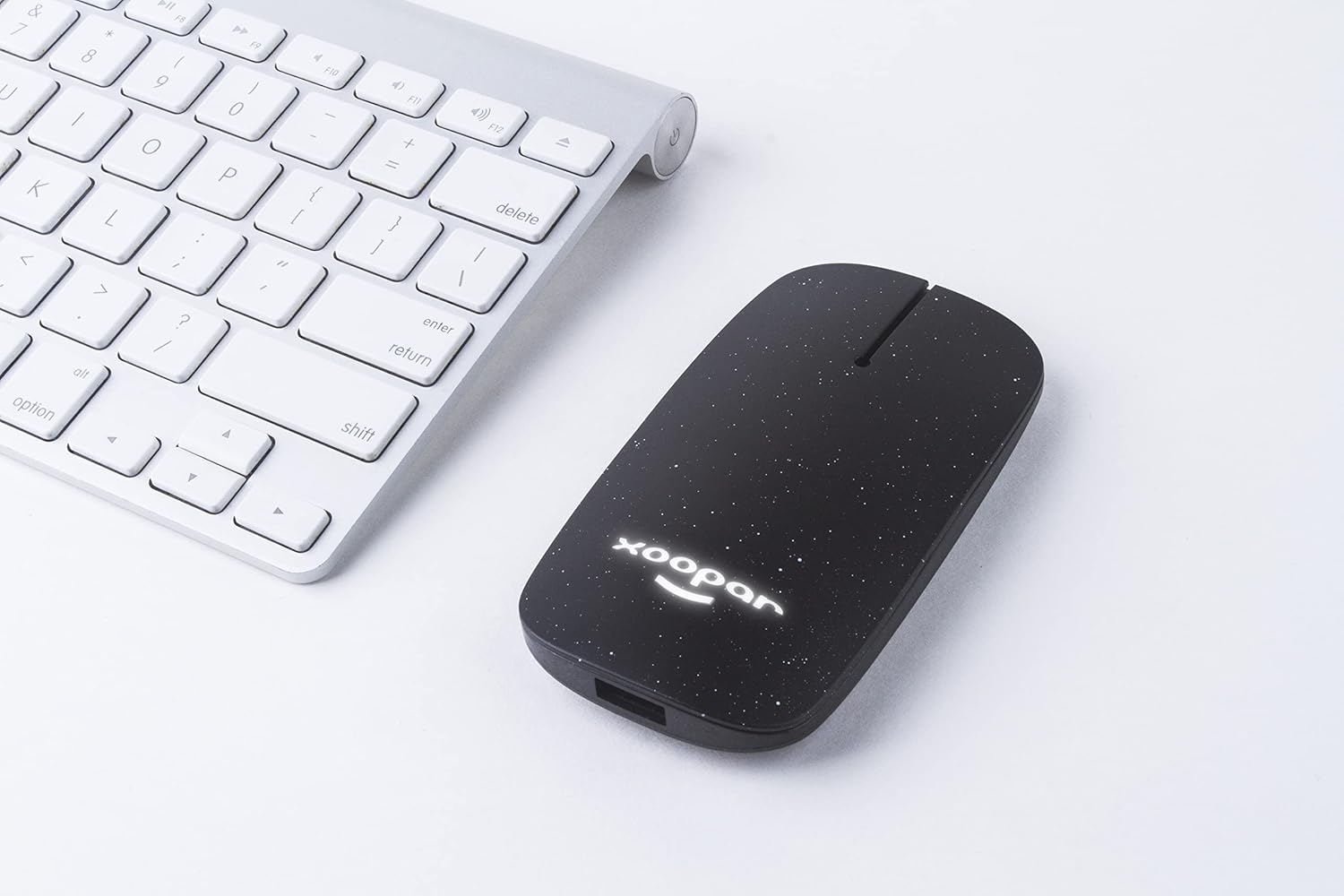 Xoopar Pokket Eco Wireless Mouse next to a silver keyboard