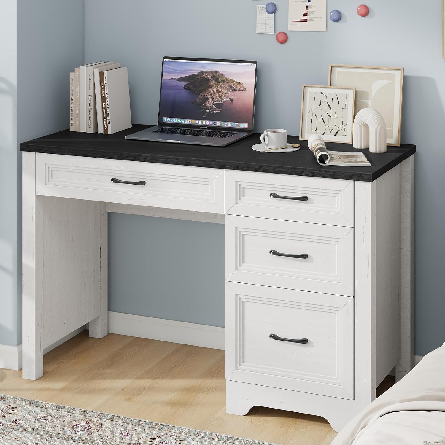 Halitaa Farmhouse Executive Desk with a laptop, coffee cup, and decorative items on its spacious black wood grain desktop.